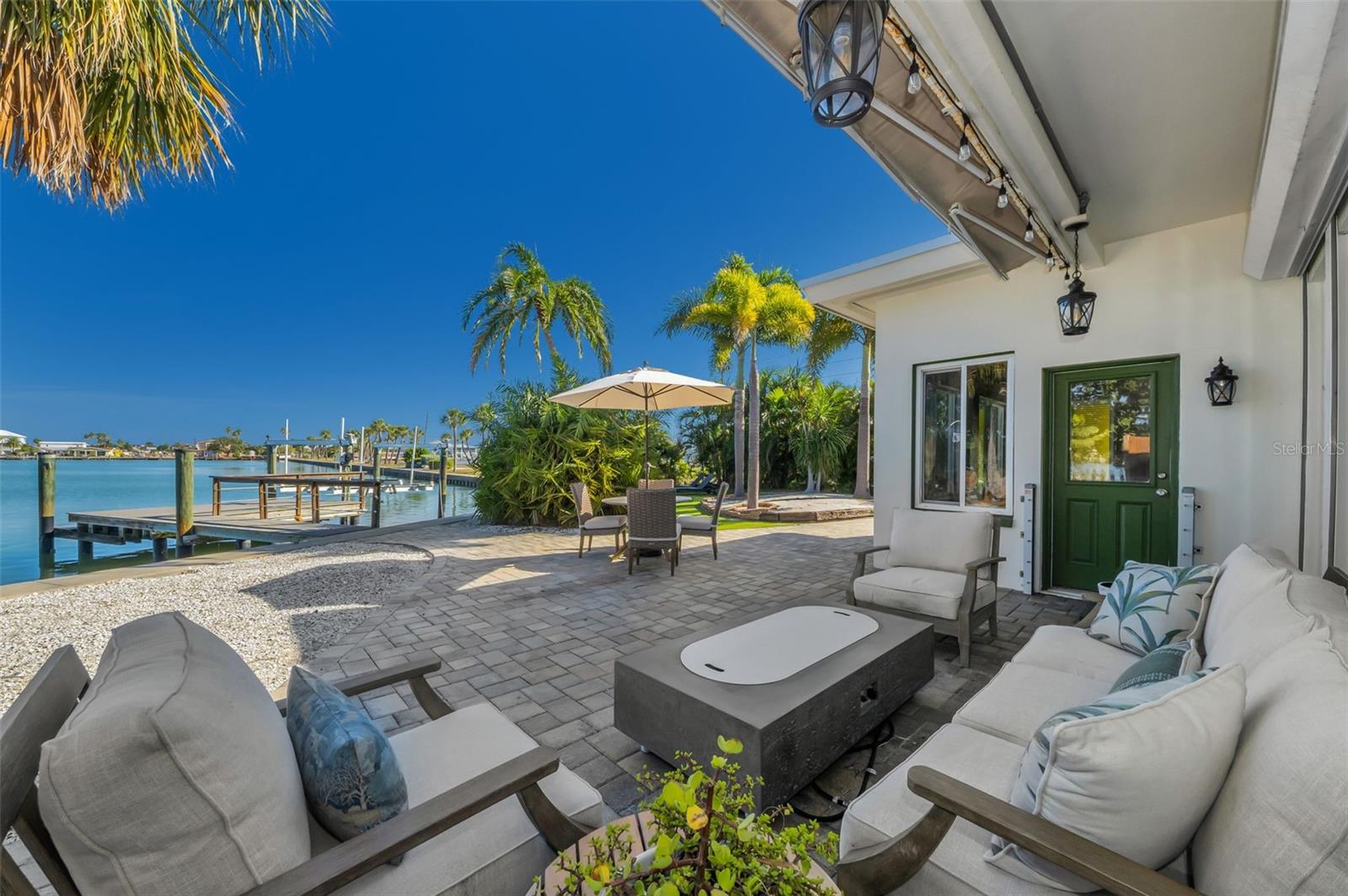 Partially covered patio overlooking the sparkling waters.