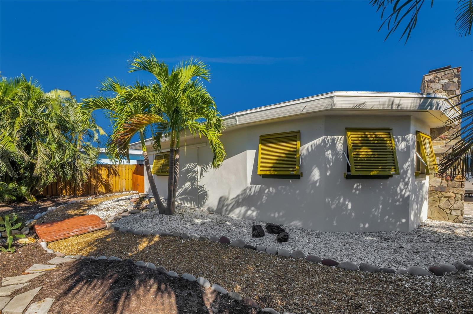 Xeriscaped with lush palm trees.