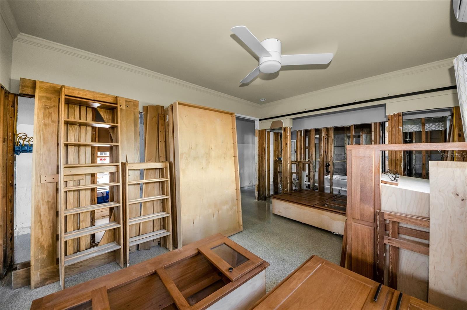 Large second bedroom is currently storing the salvaged custom designed wood six bunk and kitchen cabinets.