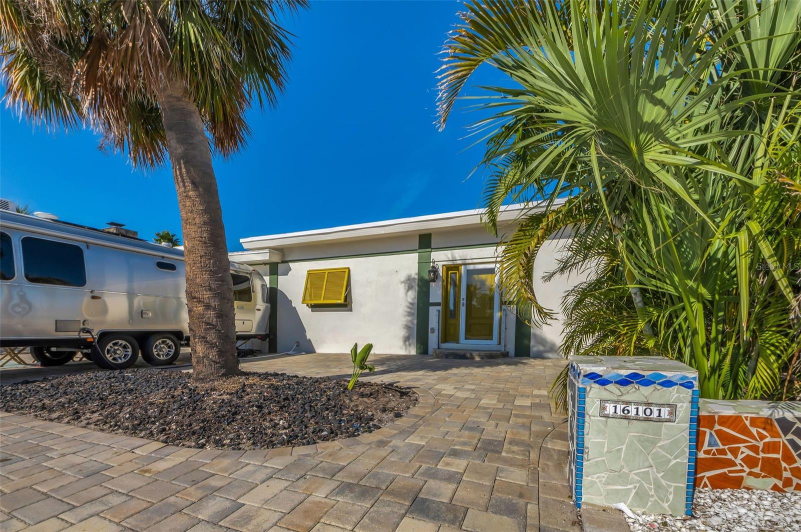 Nicely landscaped and appointed driveway.