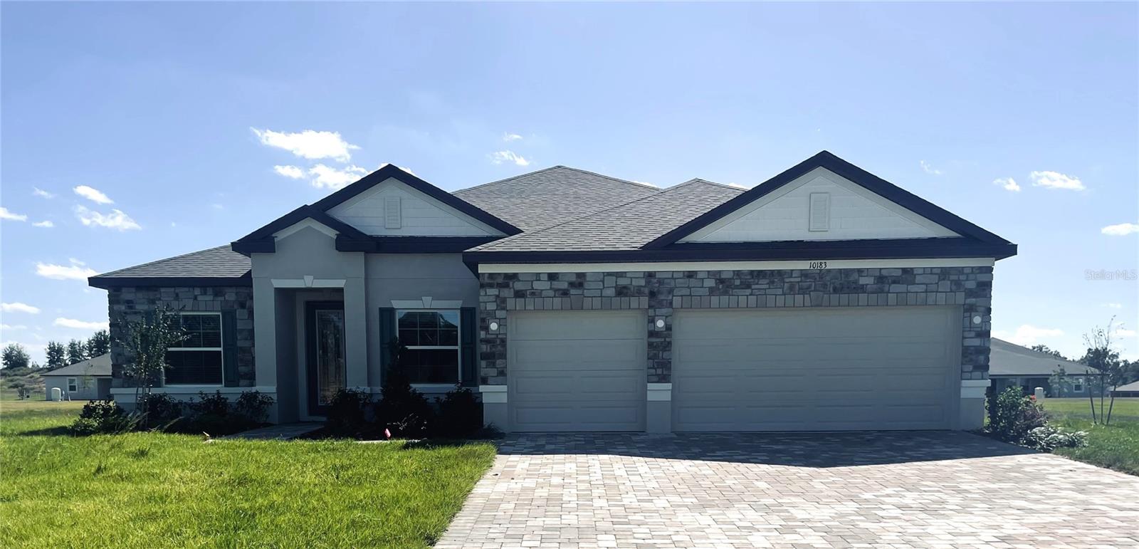 Stunning Exterior with Stone Accent, Block Construction, Entry & Driveway Pavers, 3 Car Garage