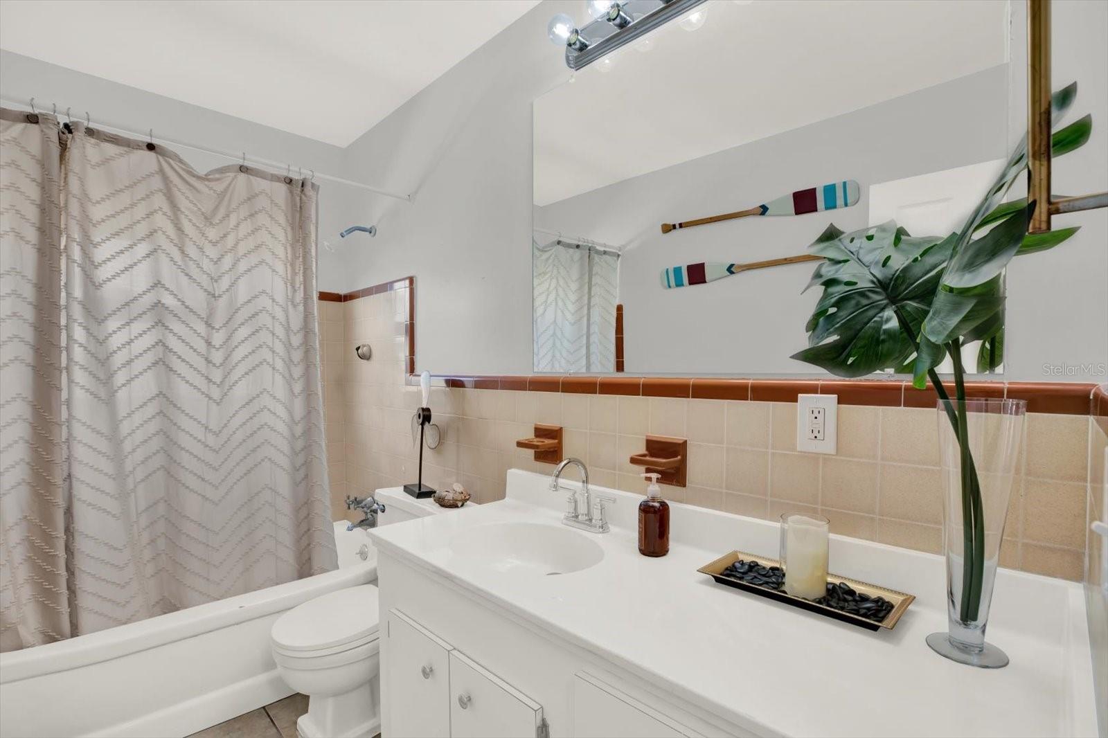 Full bathroom w/tub and shower combo.