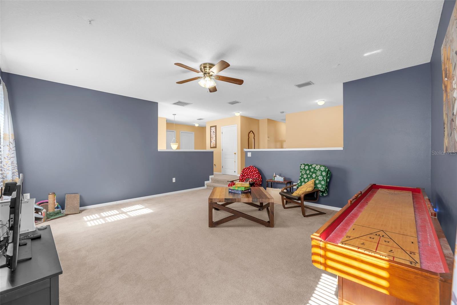 2nd floor Bonus room is steps from the top of the staircase and has allows you to  peek into the first floor foyer.