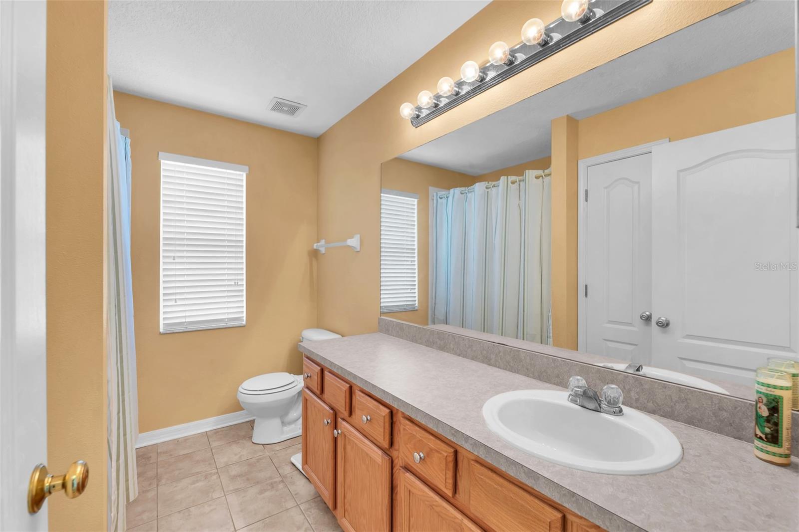 Shared full bathroom upstairs has a tub/shower combination and a large vanity with lots of storage.