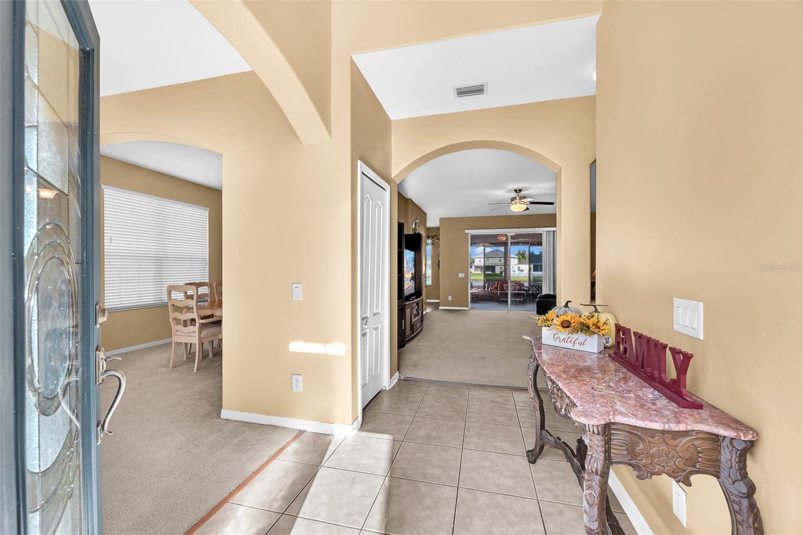 Step through the two-story foyer into bright, open spaces that include a formal living and dining room, an open family room, and an upgraded kitchen.