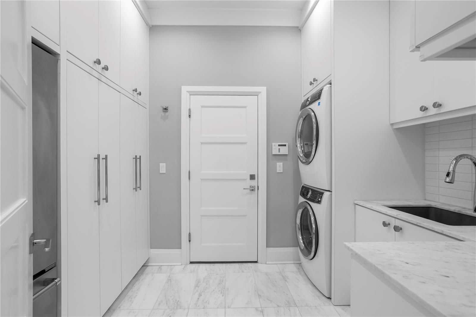 The downstairs laundry utility room and the first of two within the home