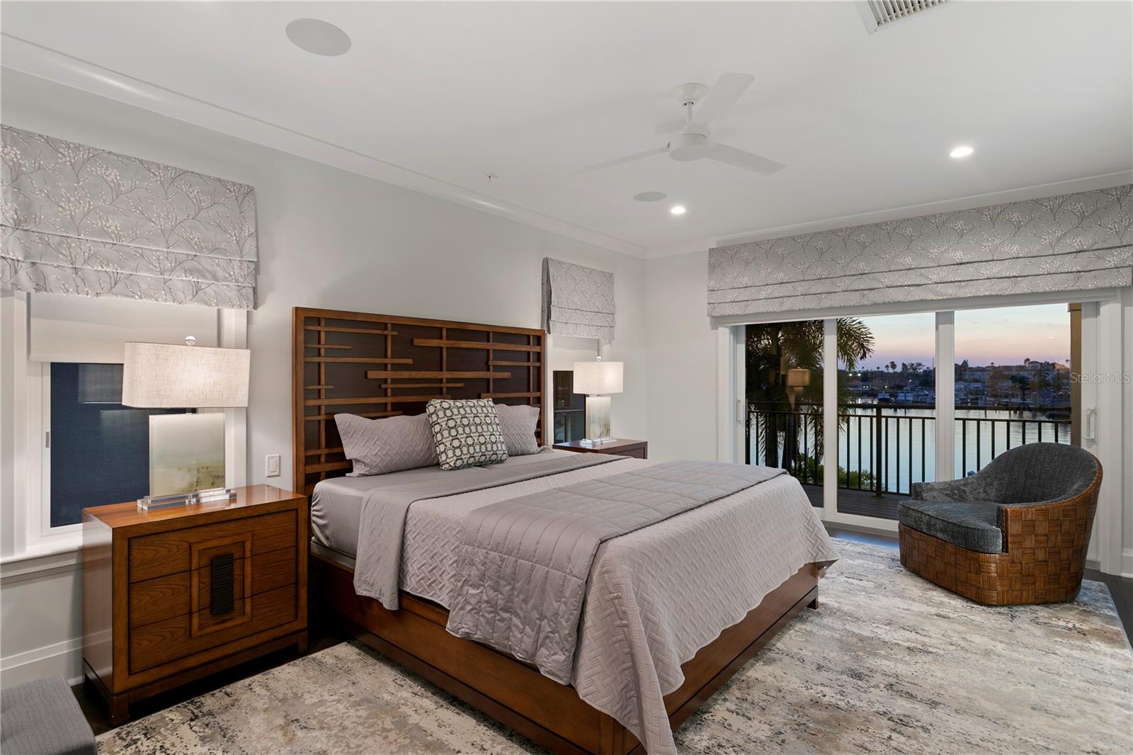 The primary retreat is complete with a private balcony overlooking serene water views