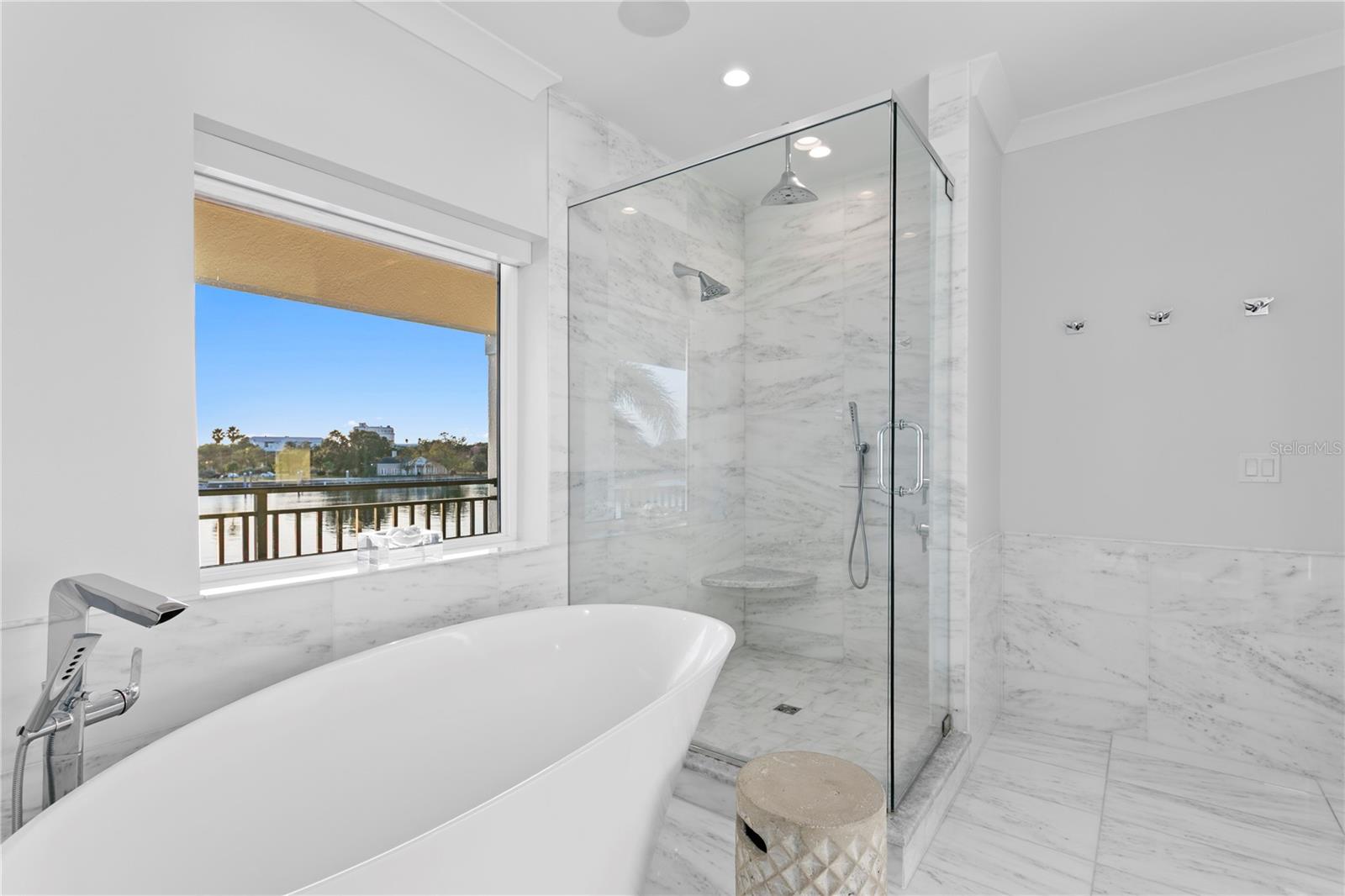 The soaking tub is positioned to capture its own waterfront vista day...