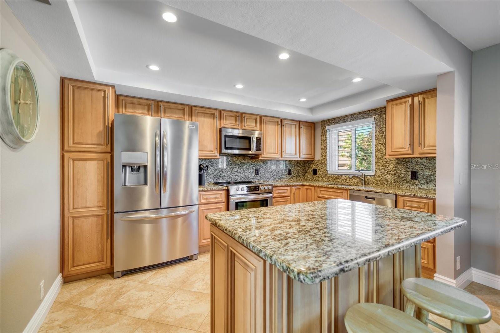 Beautiful kitchen with granite countertops and backsplash