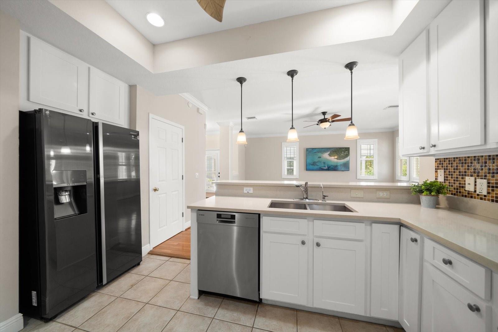 Kitchen has 42" upper cabinets and ceramic tile