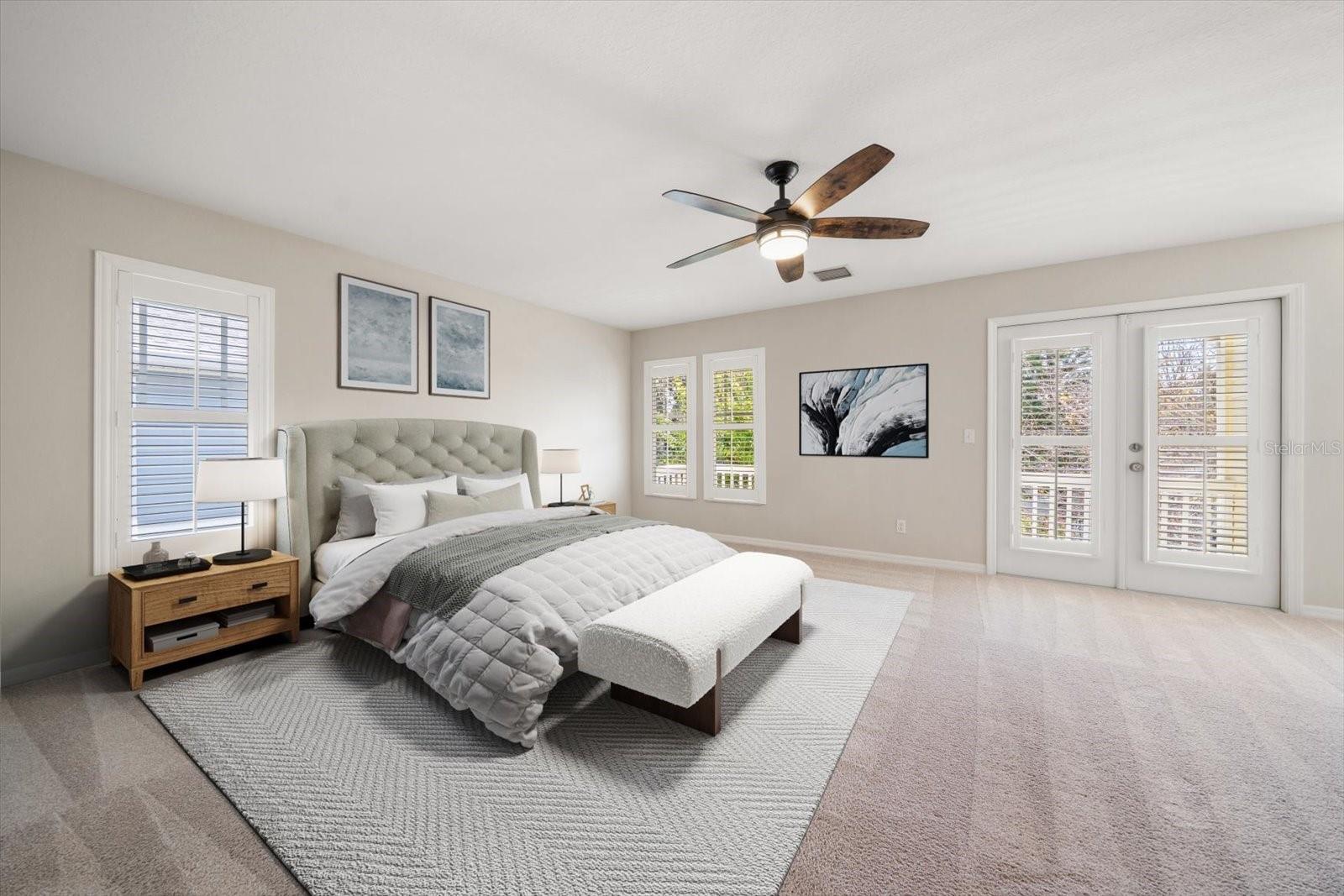 Spacious master bedroom with plantaion shutters