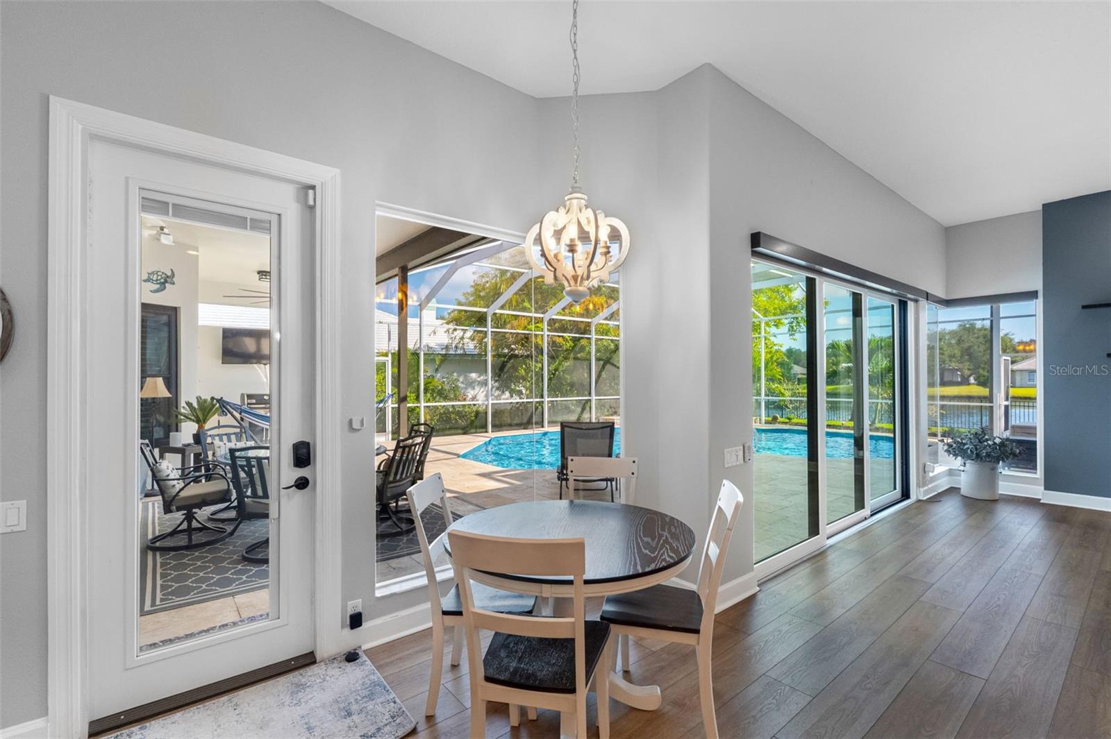 Adorable breakfast nook with lots of light and views of the pool and the water