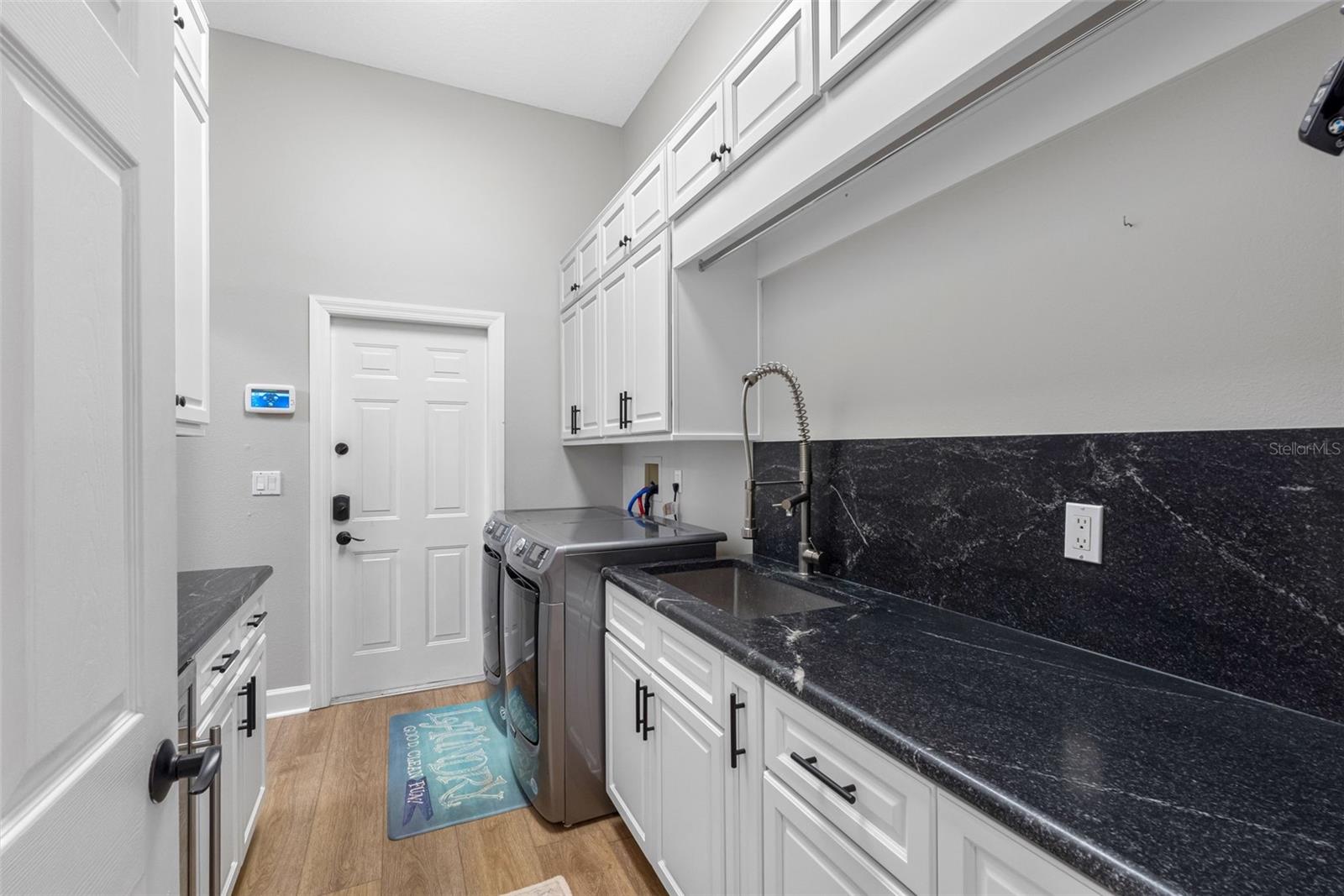 Laundry room with tons of cabinets and shelves