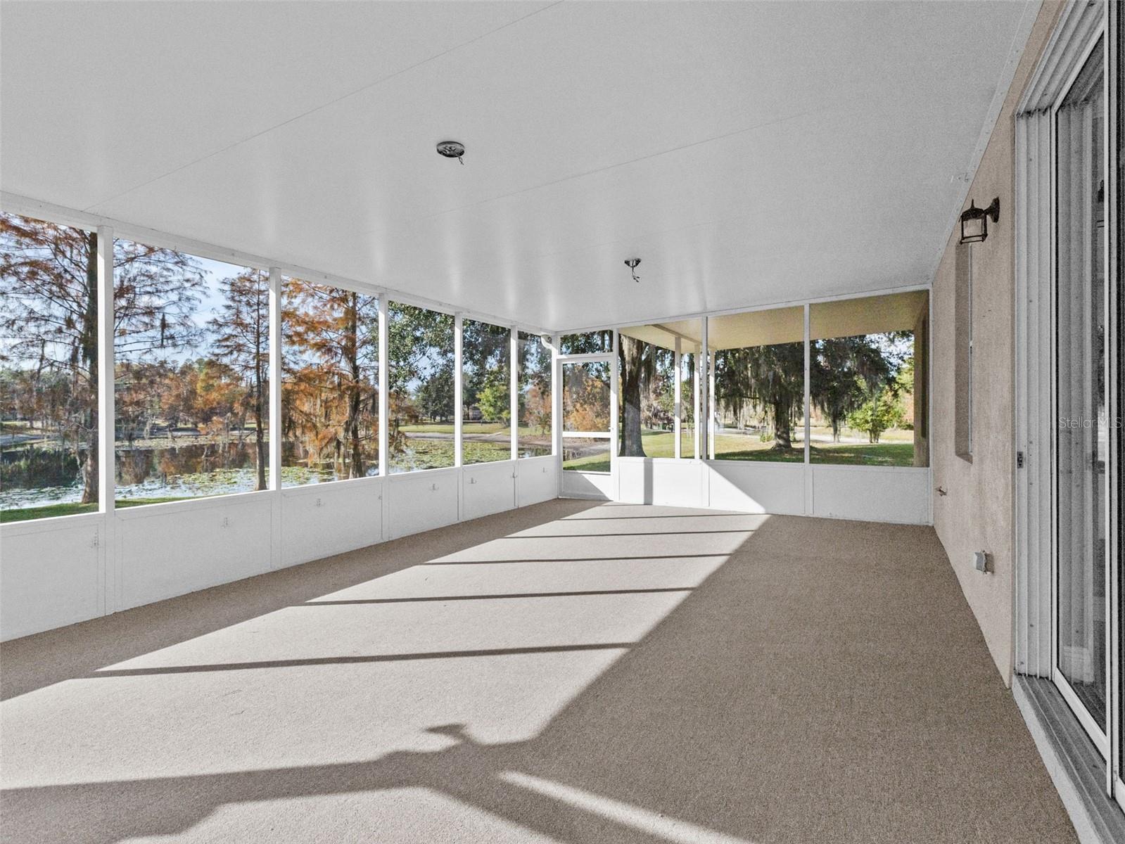 Outdoor covered lanai with brand new carpet and screens
