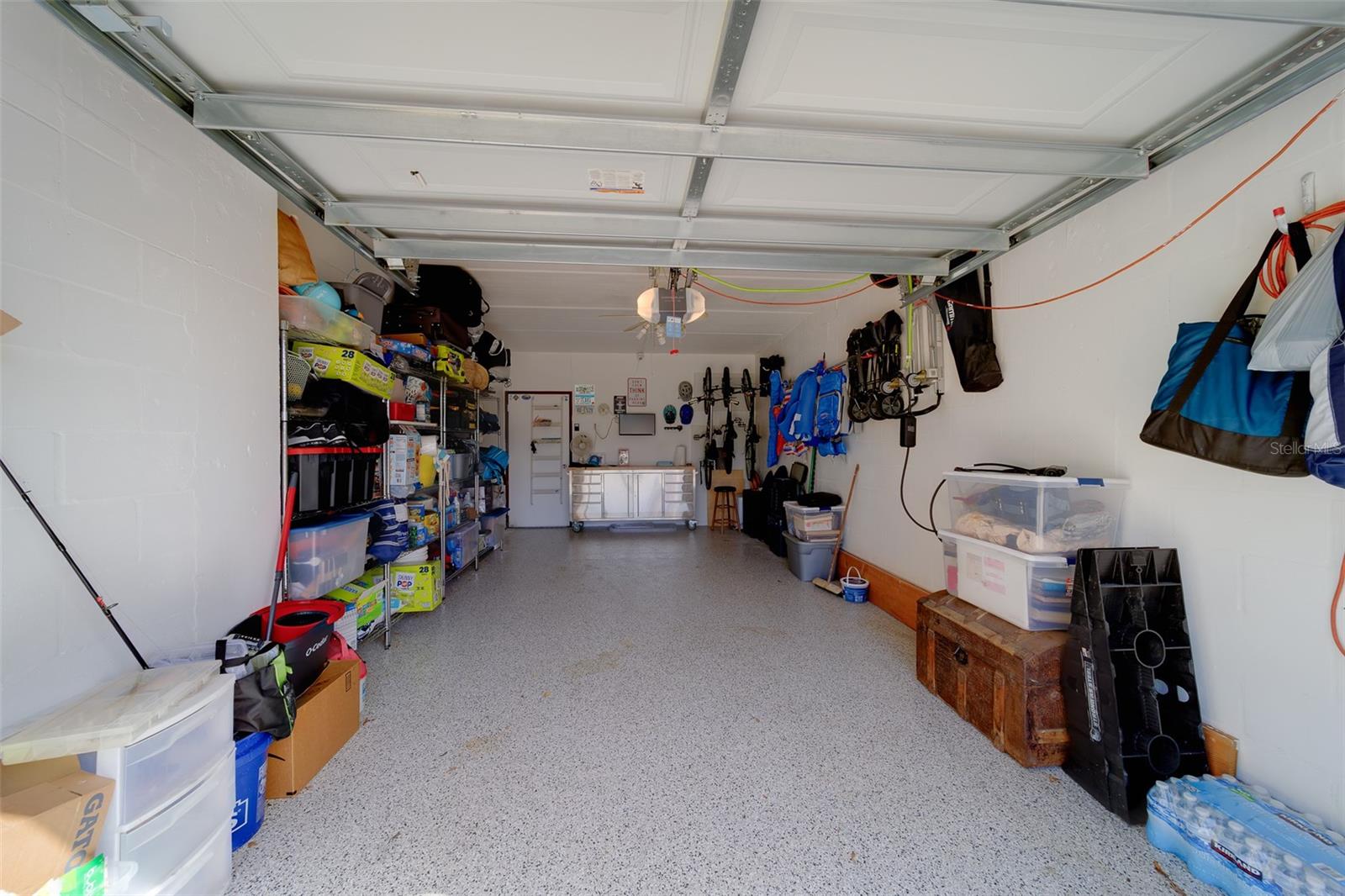 One Car Garage with newer epoxy floors and plenty of storage space