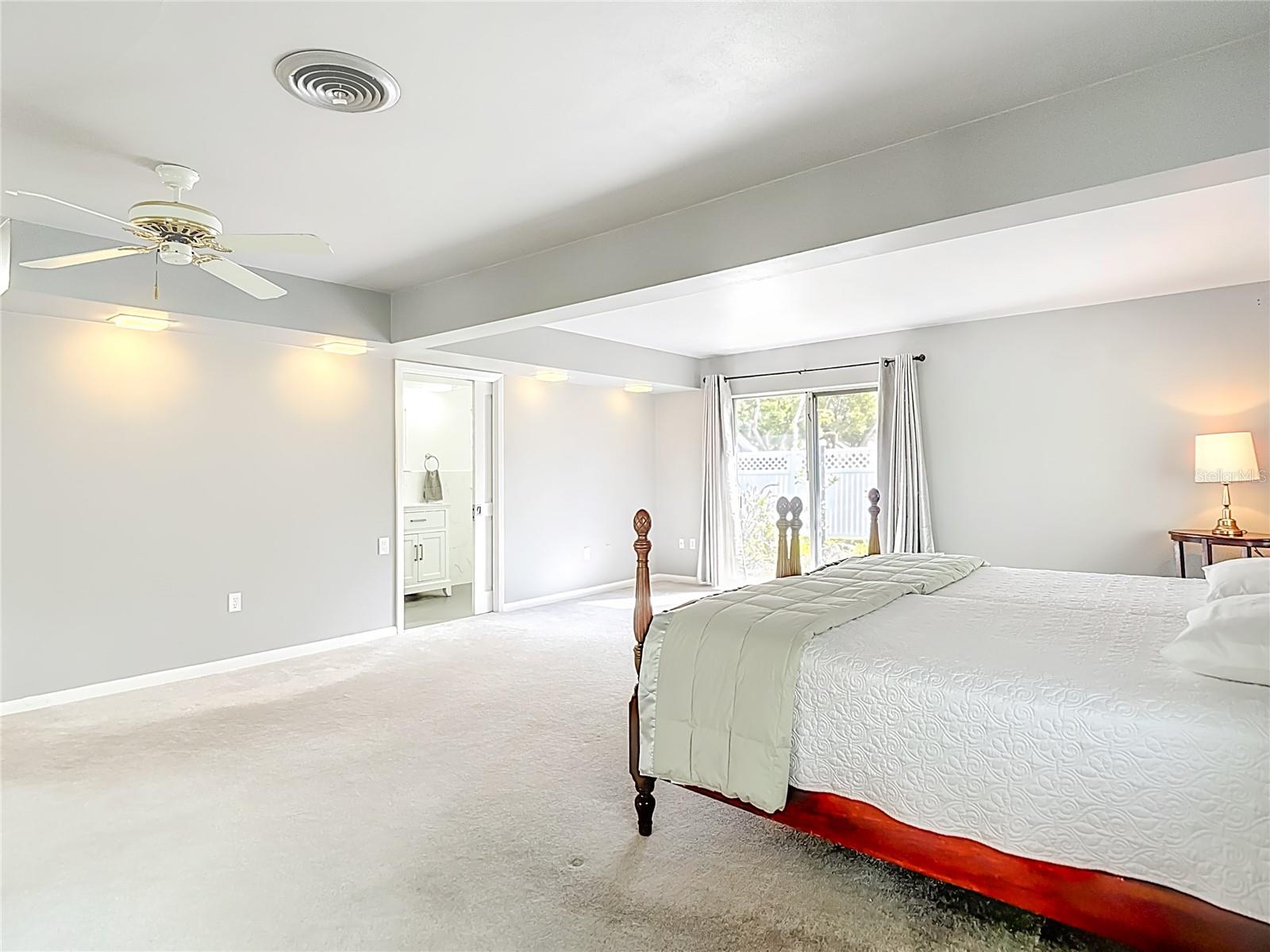 Primary Suite - Sliding Doors to Rear Yard, Green Space and Private Patio