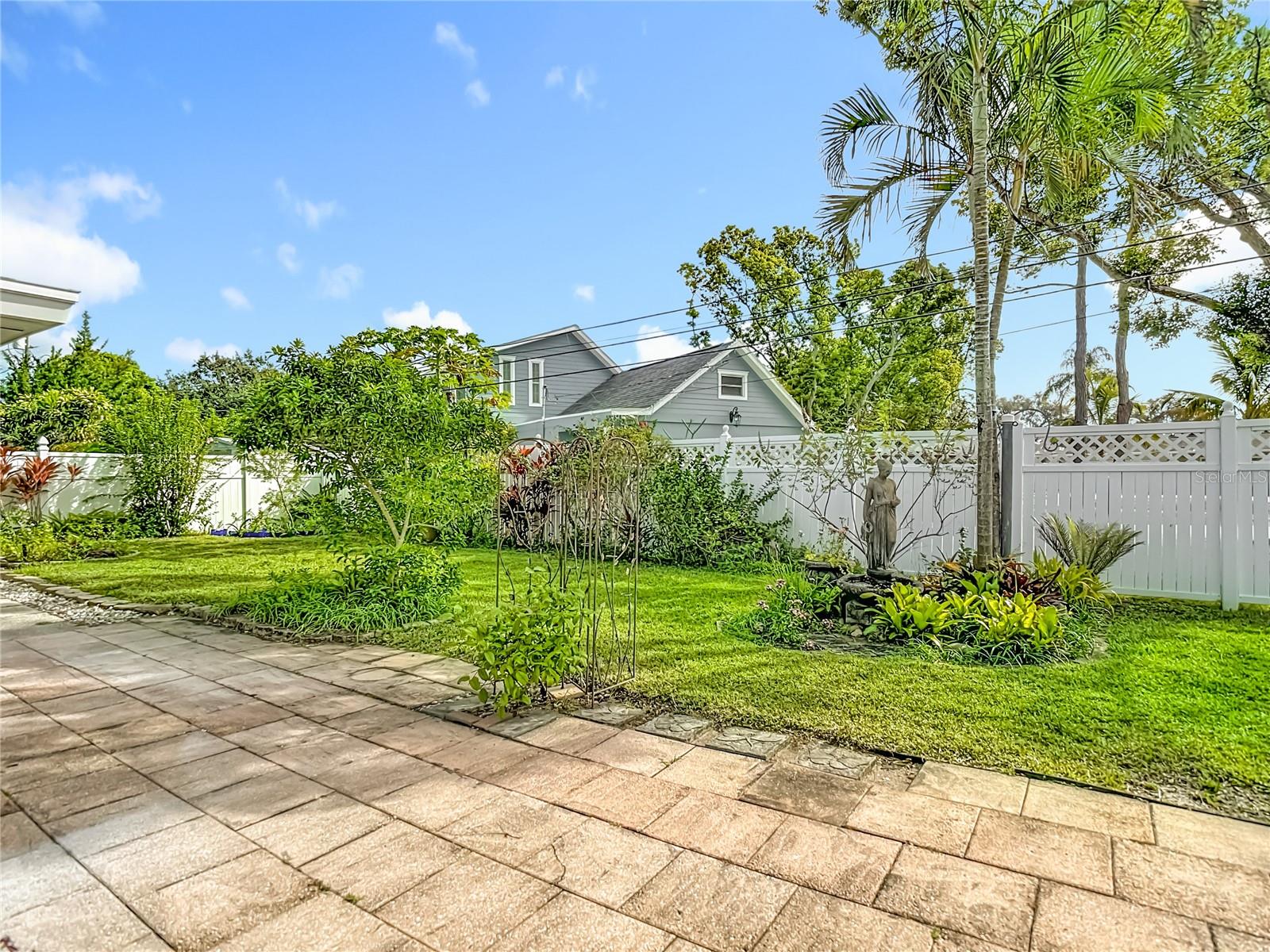 Outdoor Patio Overlooking Rear Green Space Garden and Fountain