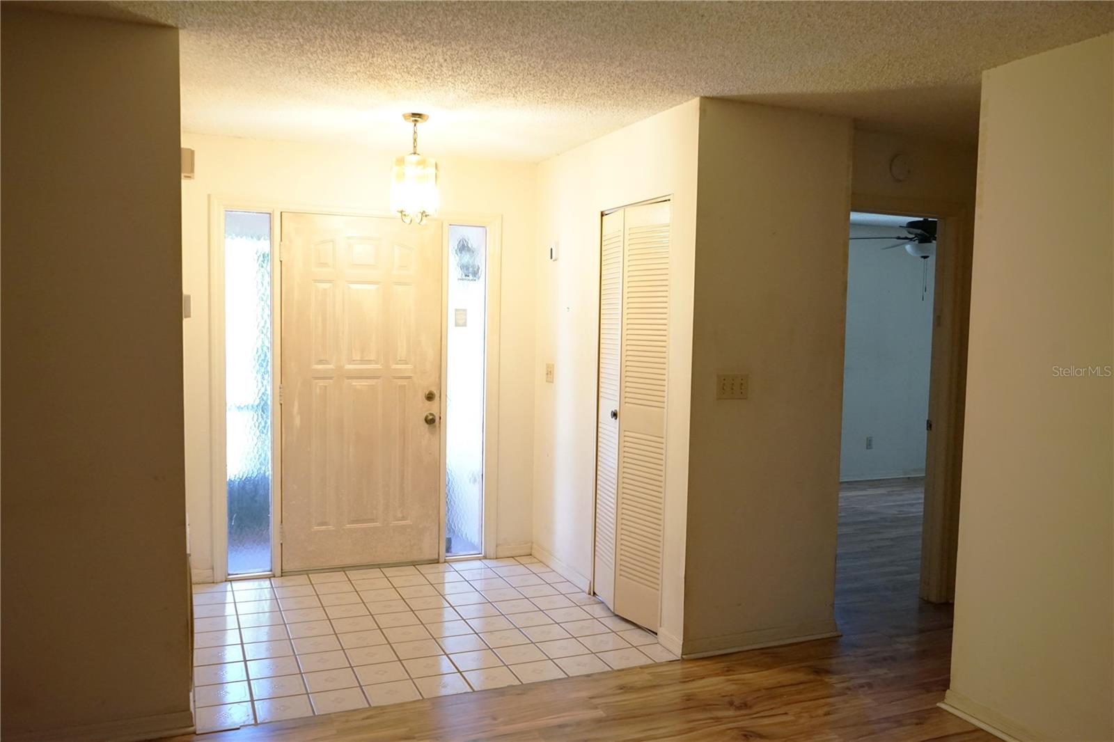 entry with coat closet and hallway to guest area