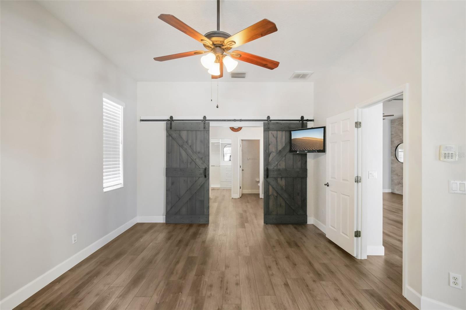 PRIMARY BEDROOM WITH CUSTOM BARN DOORS