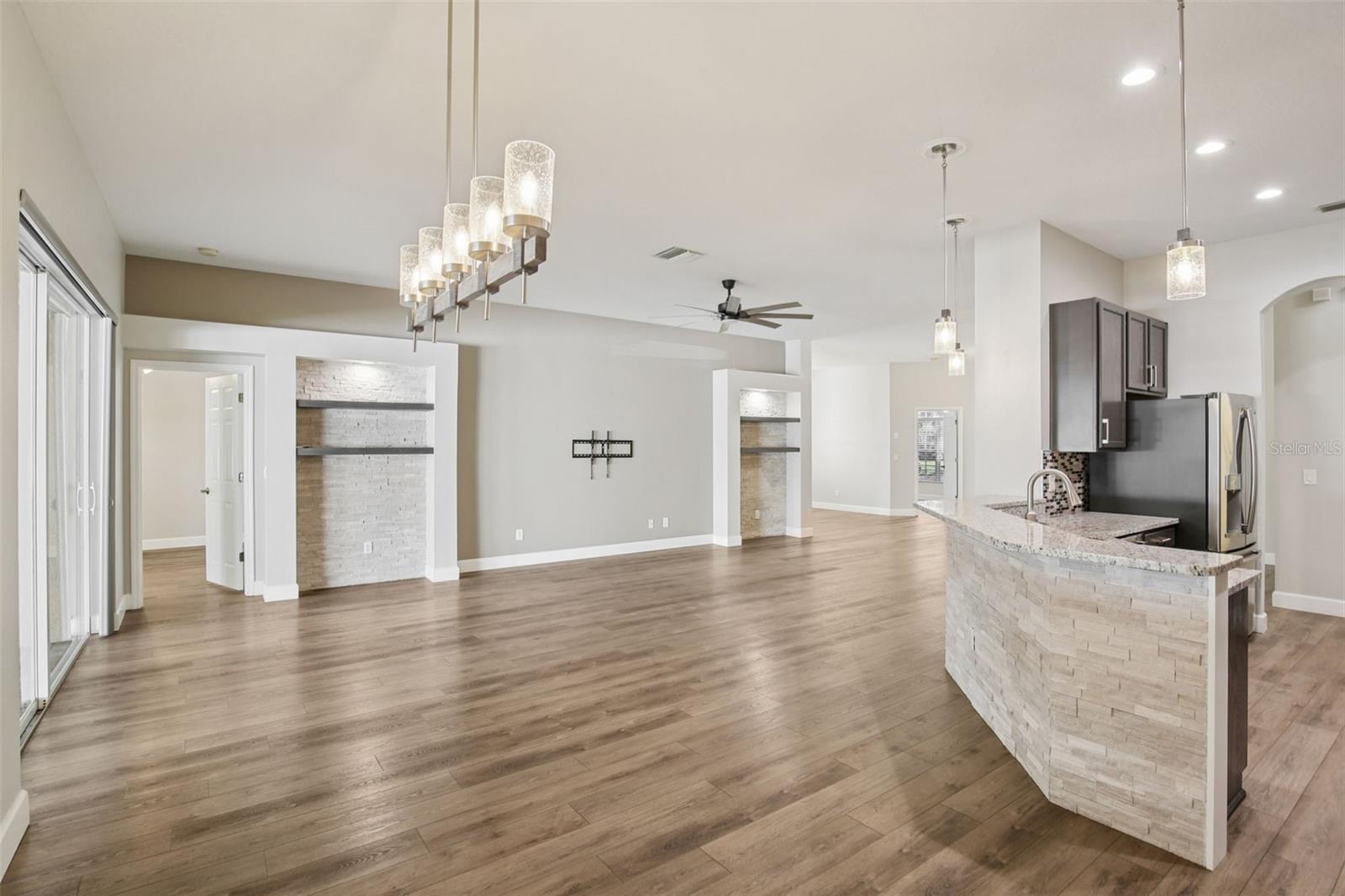 LARGE FAMILY ROOM WITH CUSTOM STONE WALL ACCENTS