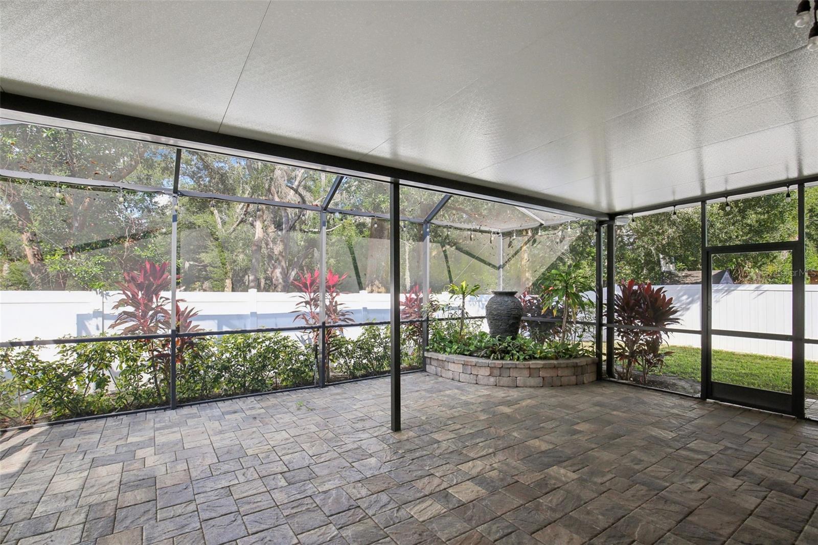 EXTENDED COVERED AND SCREEN LANAI WITH WATER FEATURE