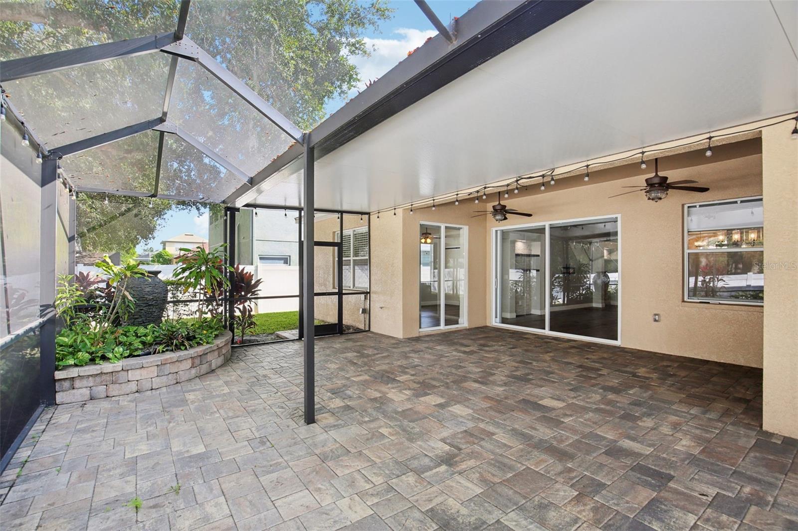 EXTENDED COVERED AND SCREEN LANAI WITH WATER FEATURE