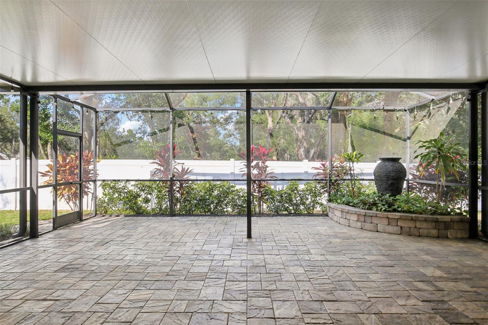 EXTENDED COVERED AND SCREEN LANAI WITH WATER FEATURE
