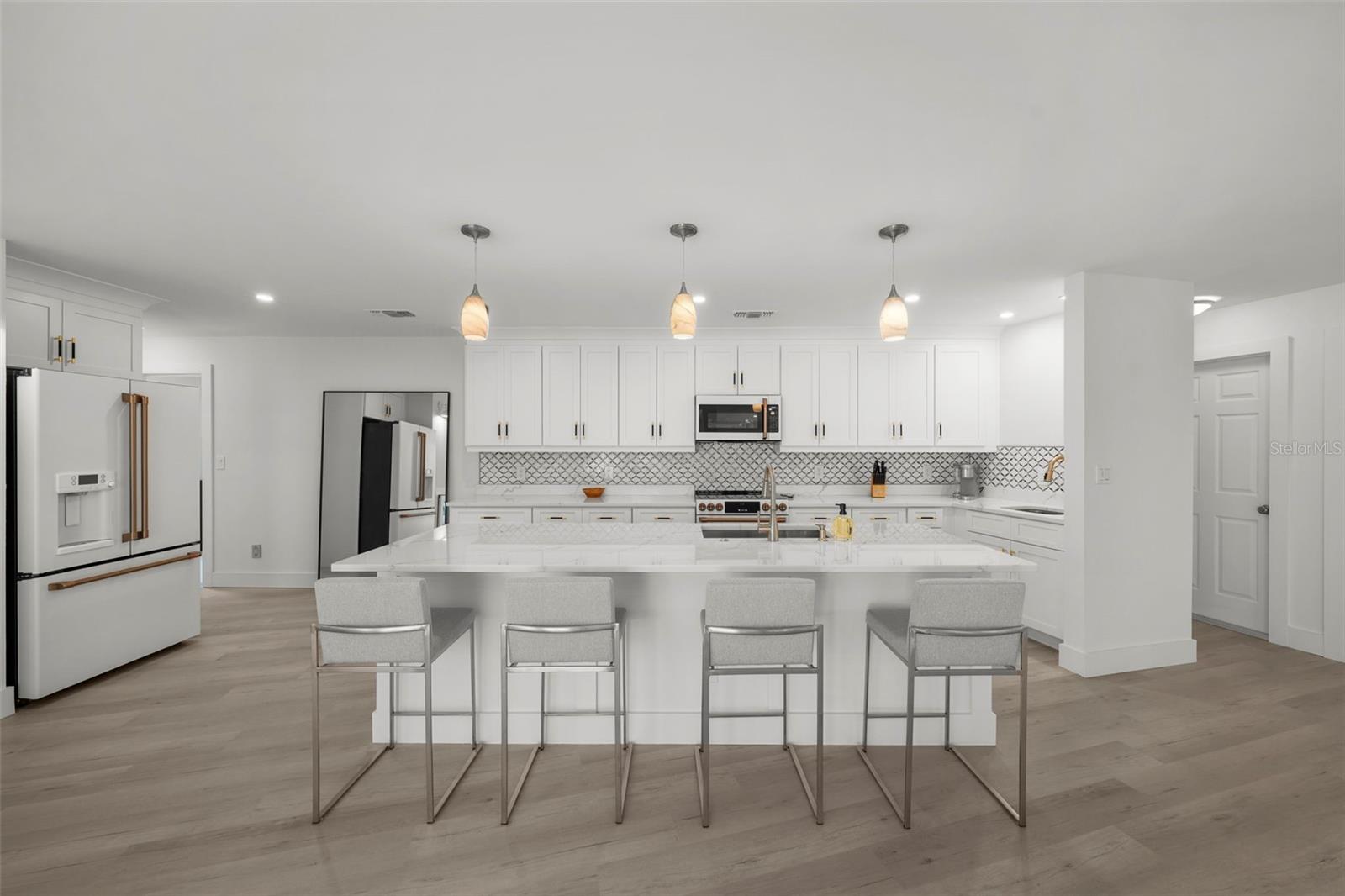 This fully re-built and re-imagined kitchen was designed with space, functionality, and all new features, with designer and modern touches throughout.
