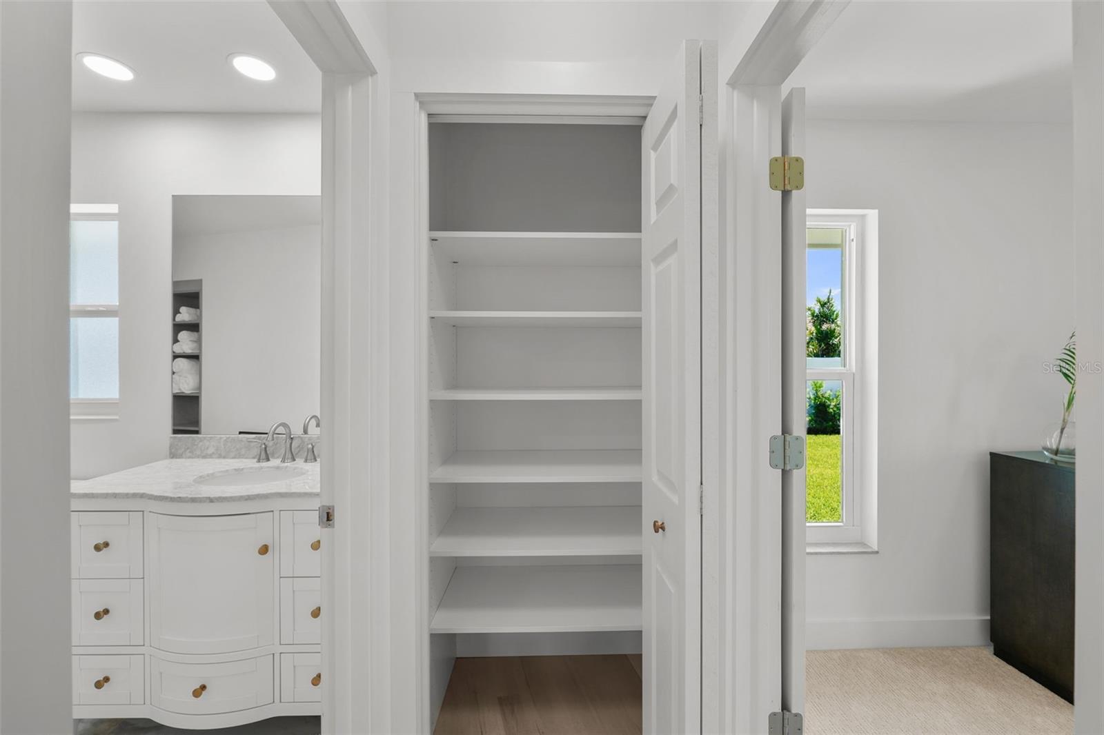 A convenient hallway linen closet positioned between the pool bath and 3rd bedroom.