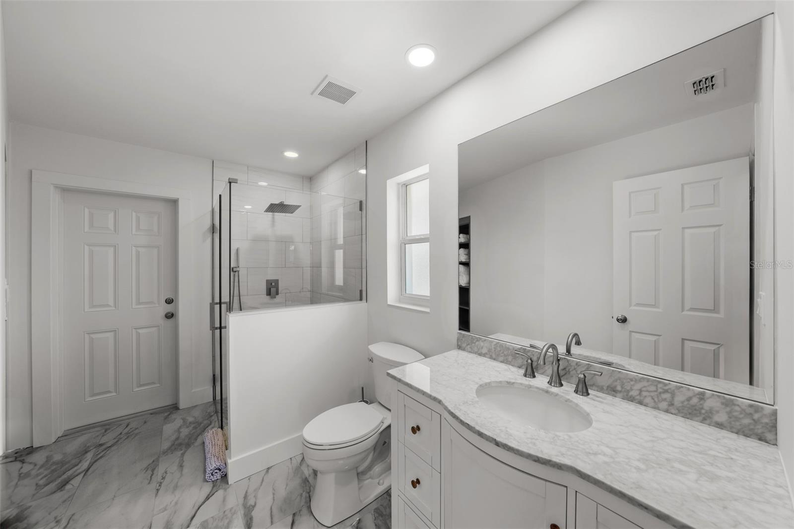 Spacious and beautifully renovated pool bath, provides direct access to the pool deck.