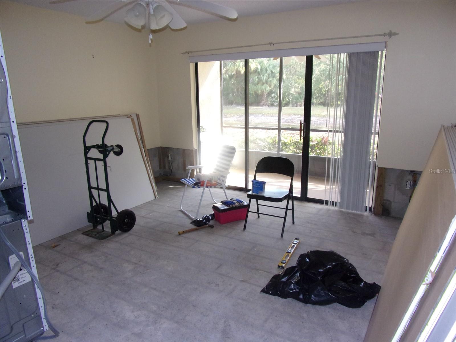 Living room has sliders and private patio overlooking conservation area