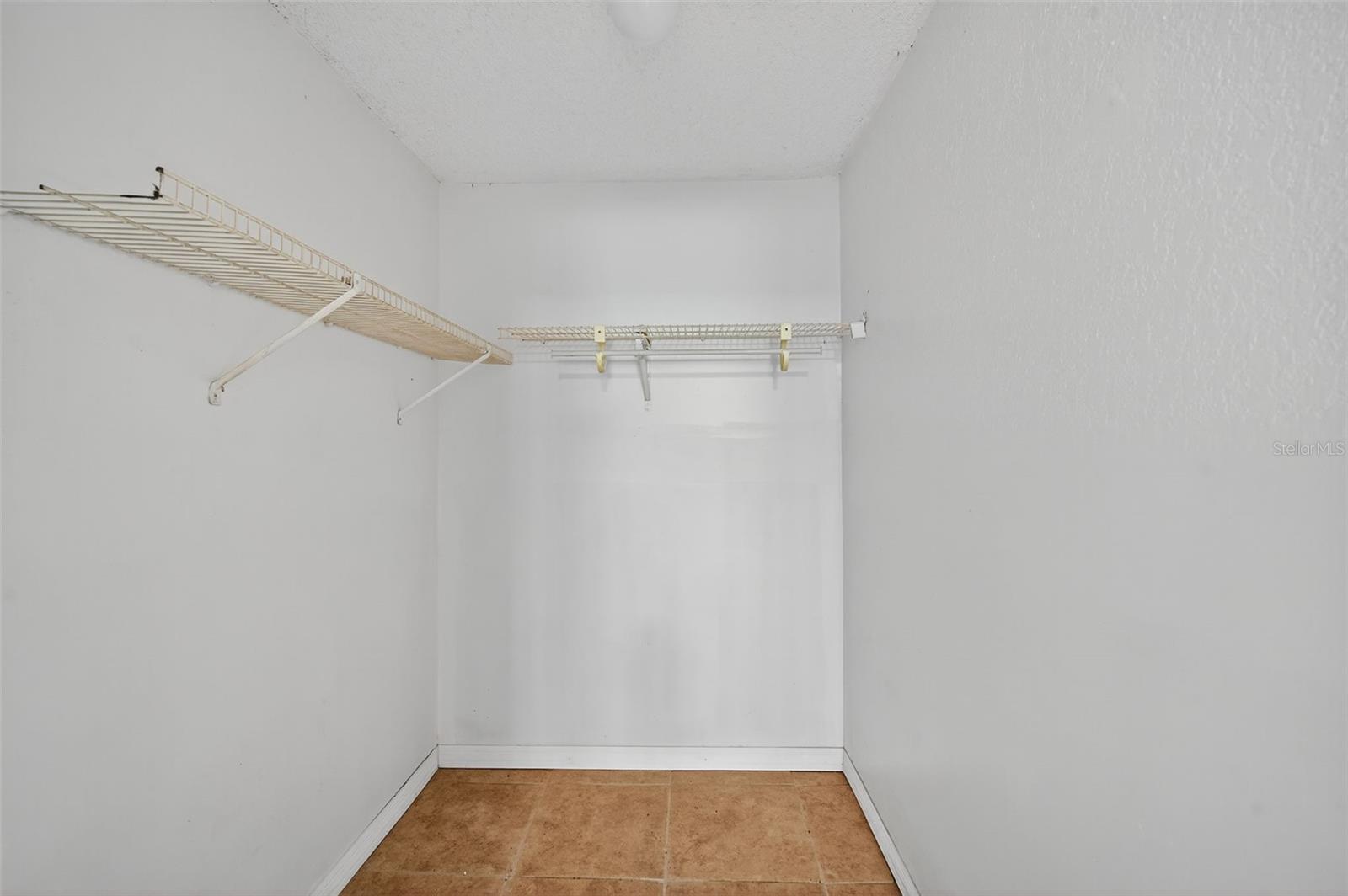 Walk-in closet of primary bedroom.