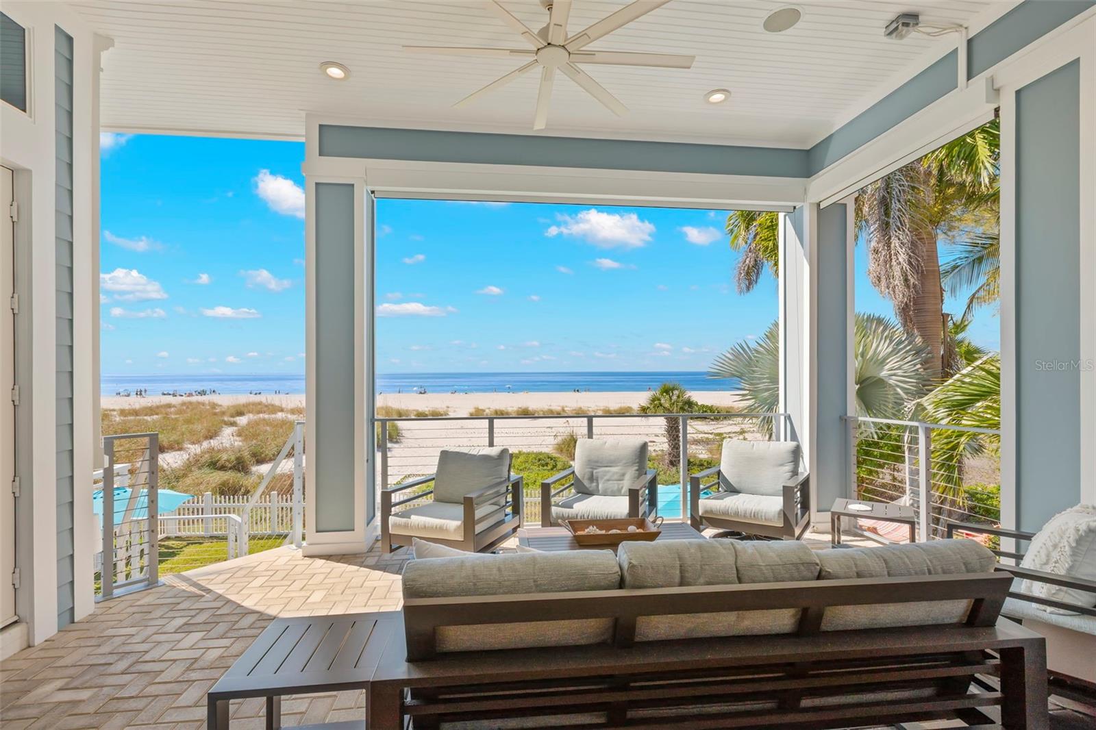 A large covered lanai from the Living Room and Dining Room overlooks the dunes and the Gulf.