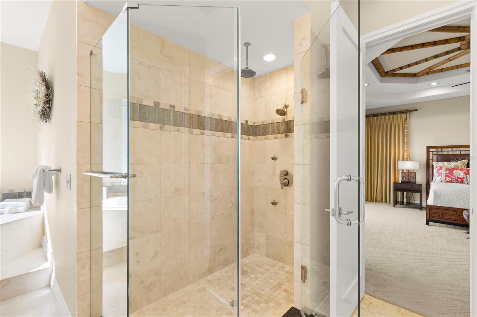 Glass enclosed shower with multiple shower heads