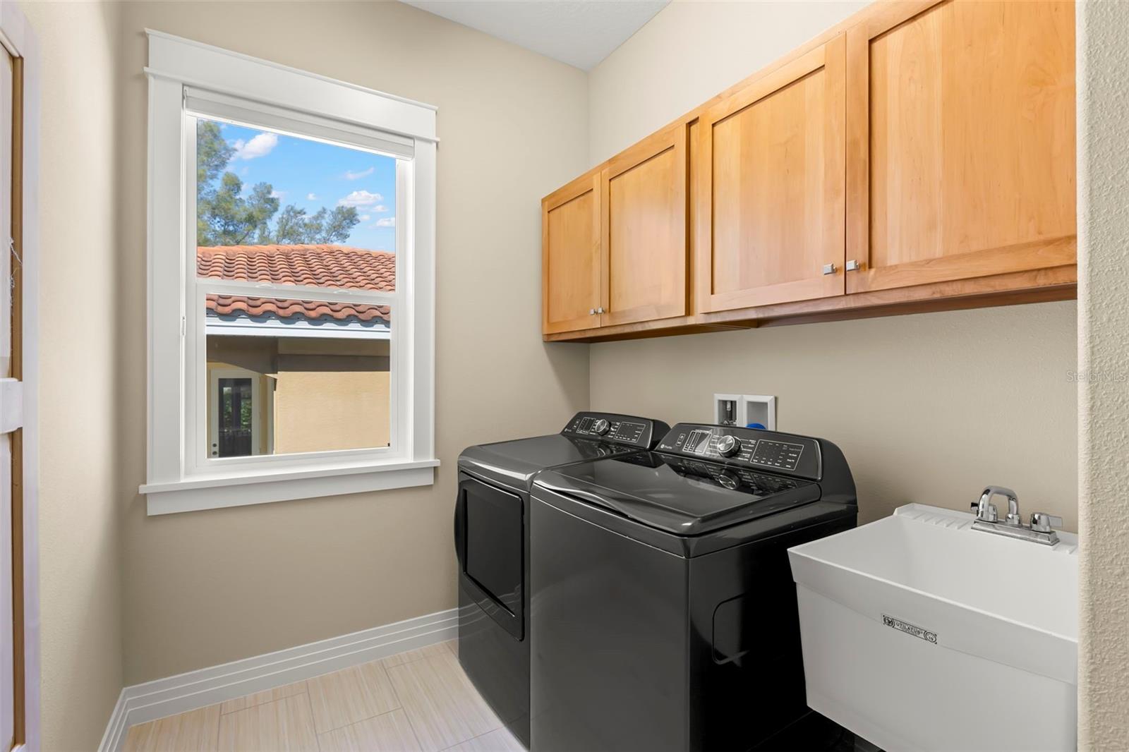 The large laundry room is on the upper level and has a built in ironing board and linen closet for additional storage.