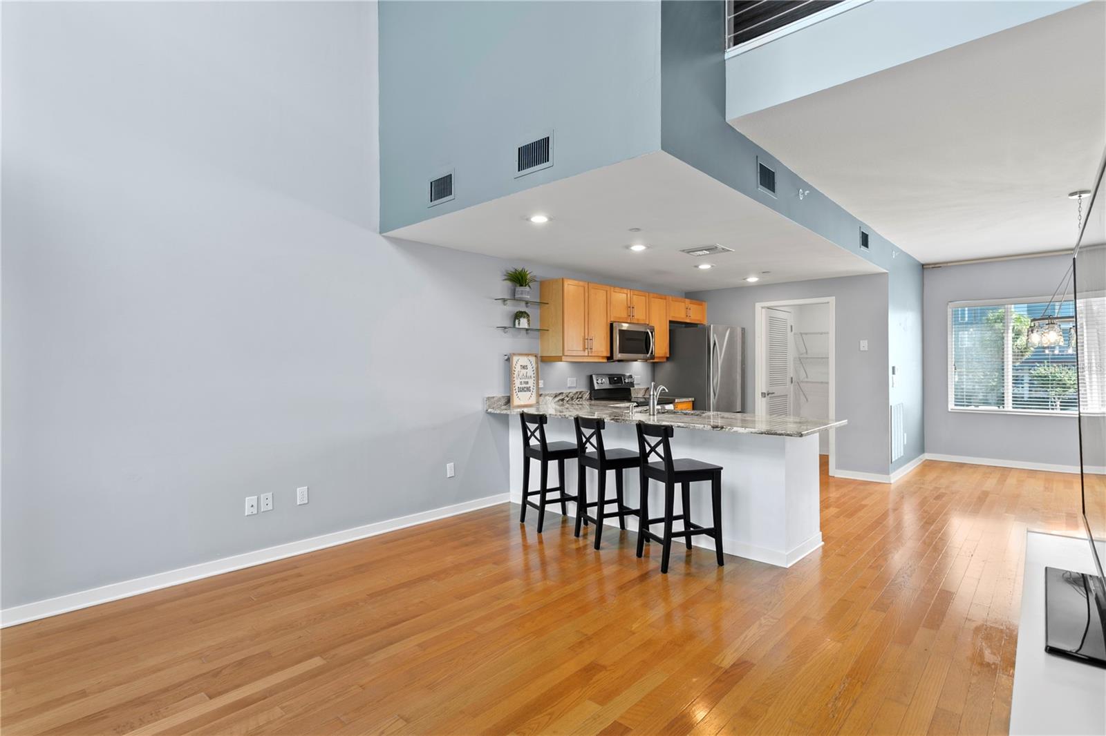 Main level (2nd) High ceilings in living area looking back to kitchen/dining room