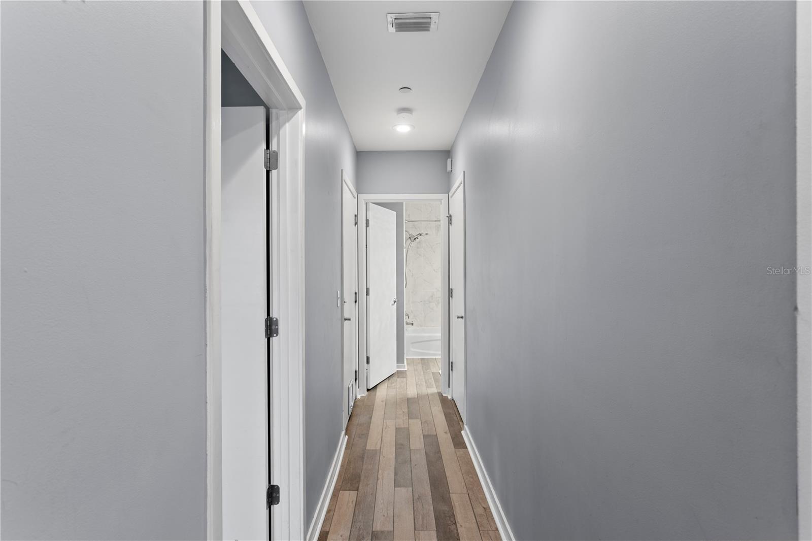 1st floor hallway leading to 1st floor bath and garage