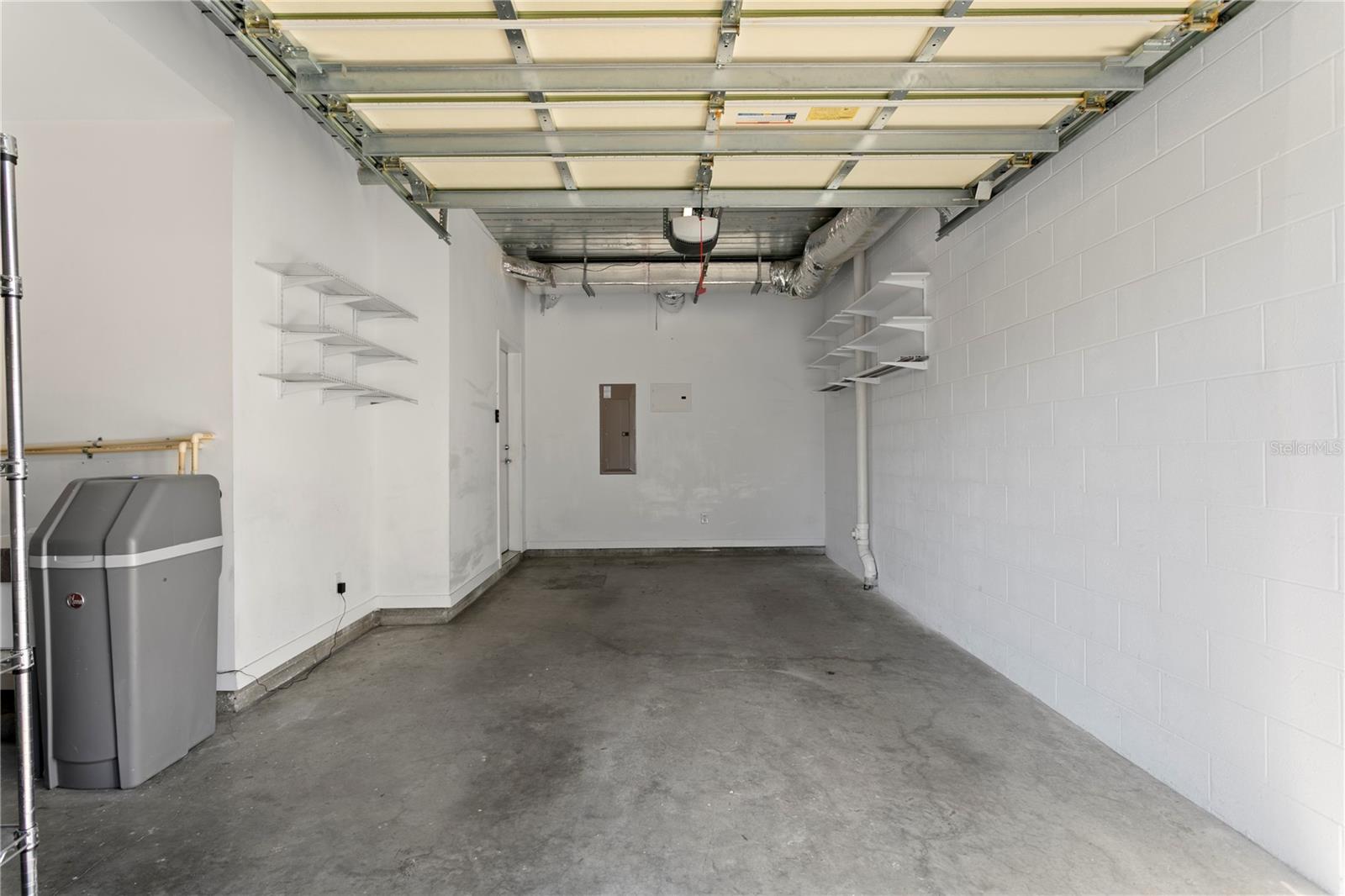 Private 1 car garage with storage and a water softener