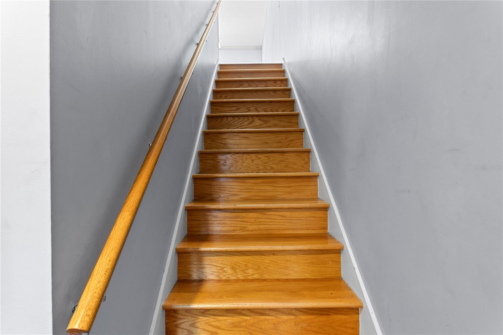 Wood stairs from 1st level leading to main level on the 2nd floor