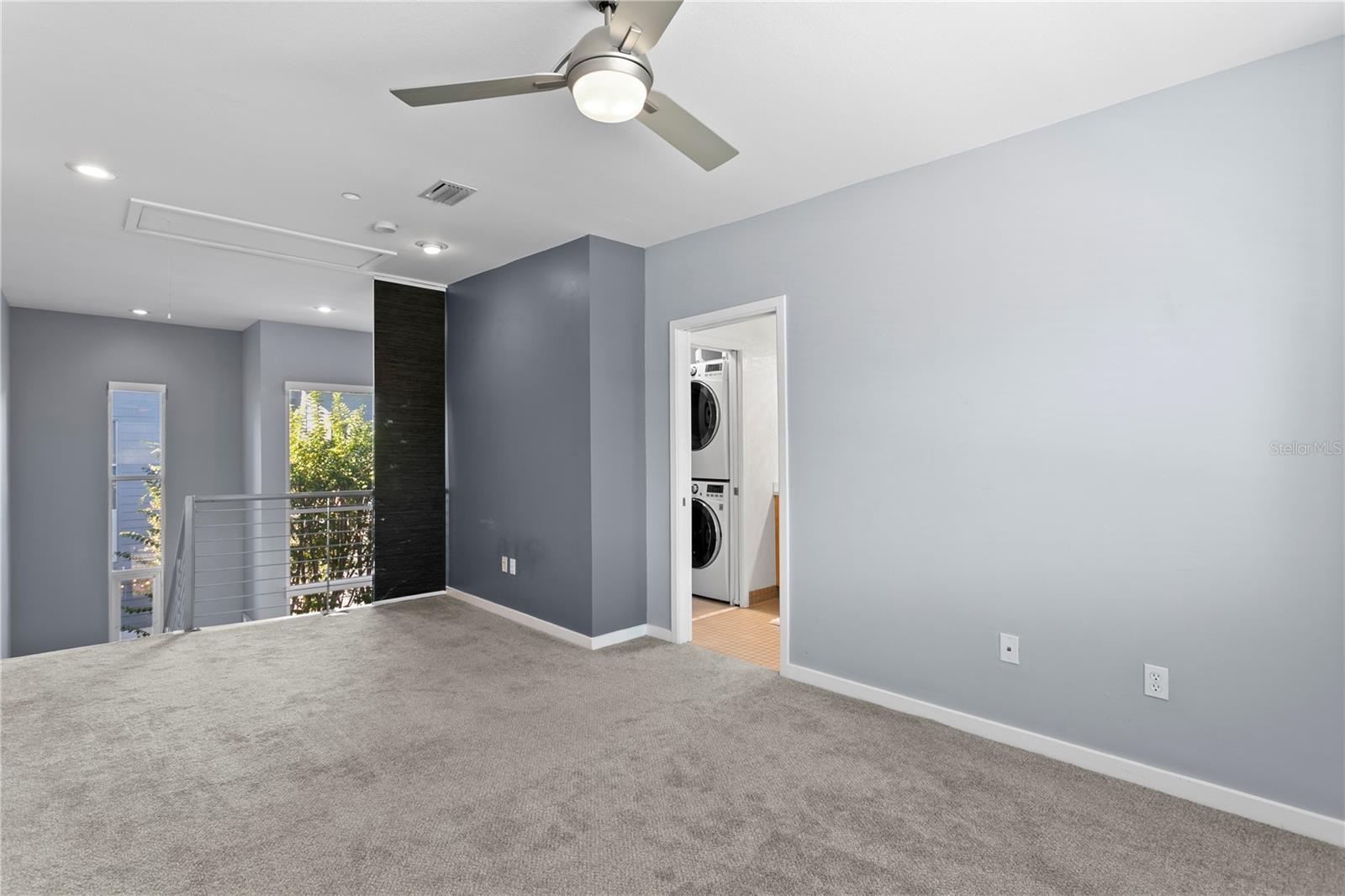 3rd floor Primary loft ensuite looking back to ensuite bath, convenient laundry area.