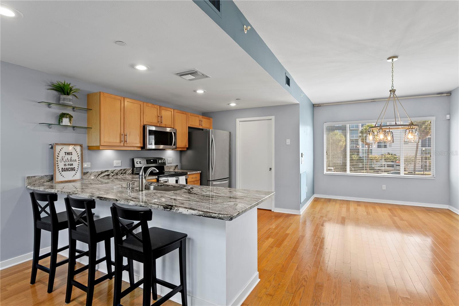 Main level-(2nd) Light and bright chef's  kitchen with newer stone counters and counter seating area