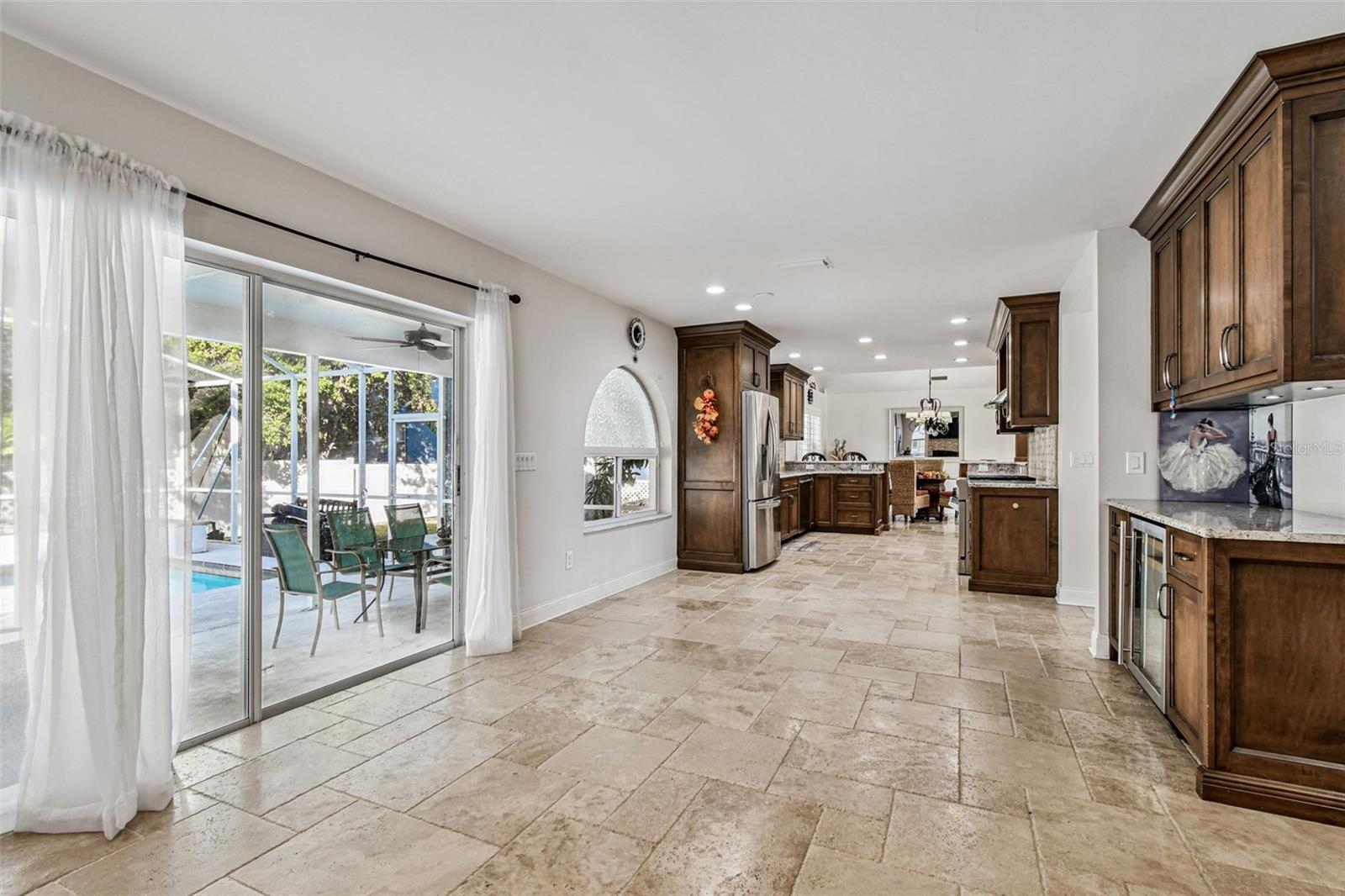 Breakfast area and sliding glass doors to screened in pool area.