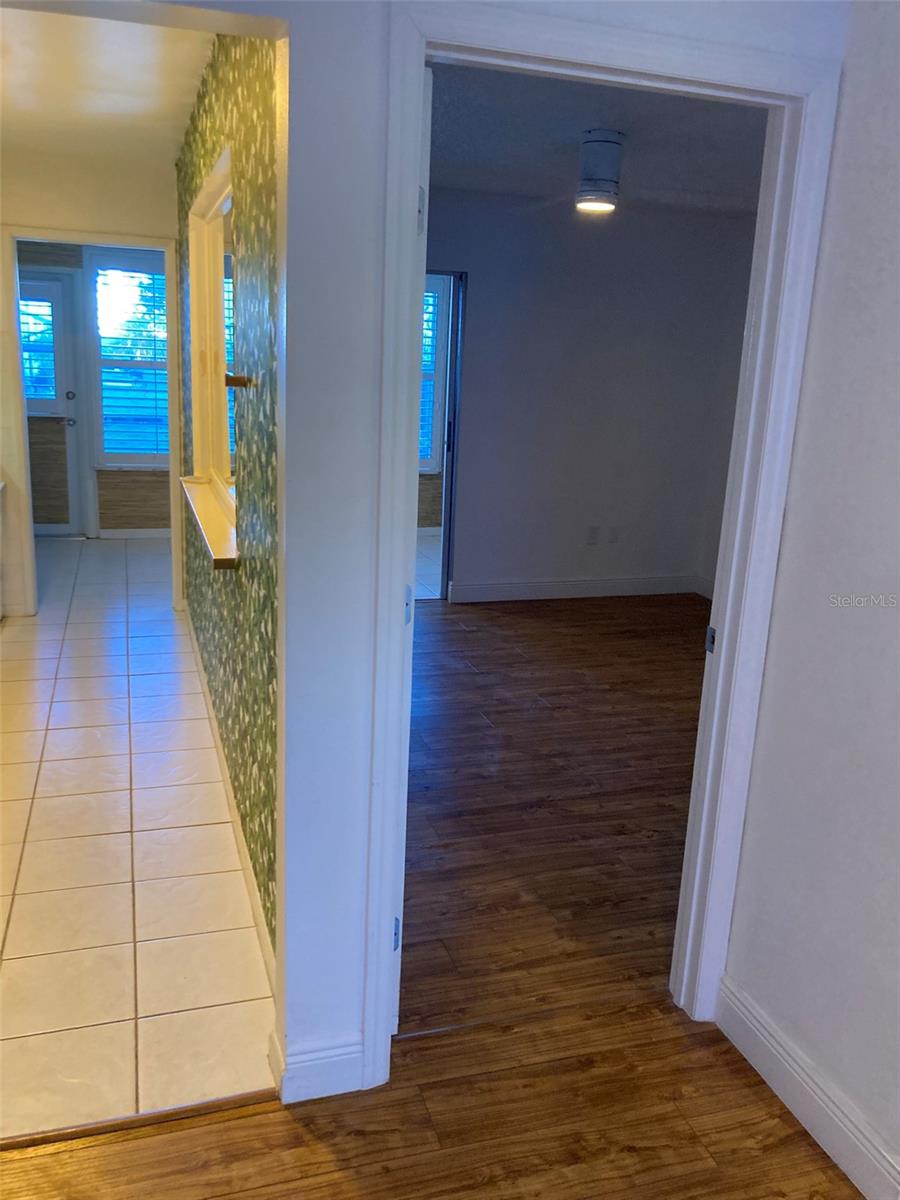Bedroom entry and view of kitchen