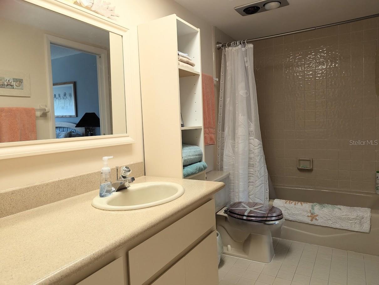 Second bathroom accessible from hall and second bedroom. Tub shower