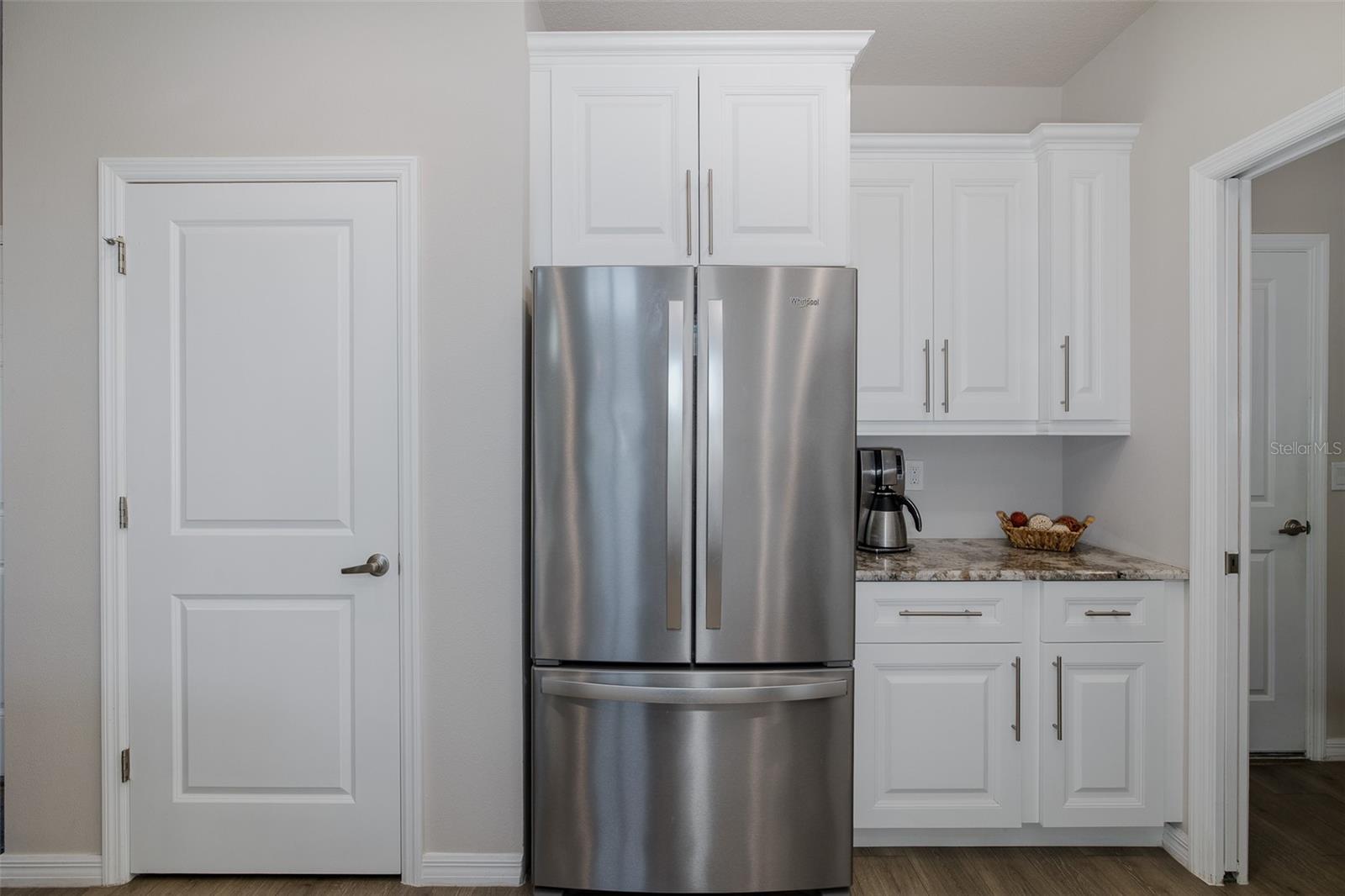 Pantry, French door Whirlpool refrigerator and coffee bar in the kitchen