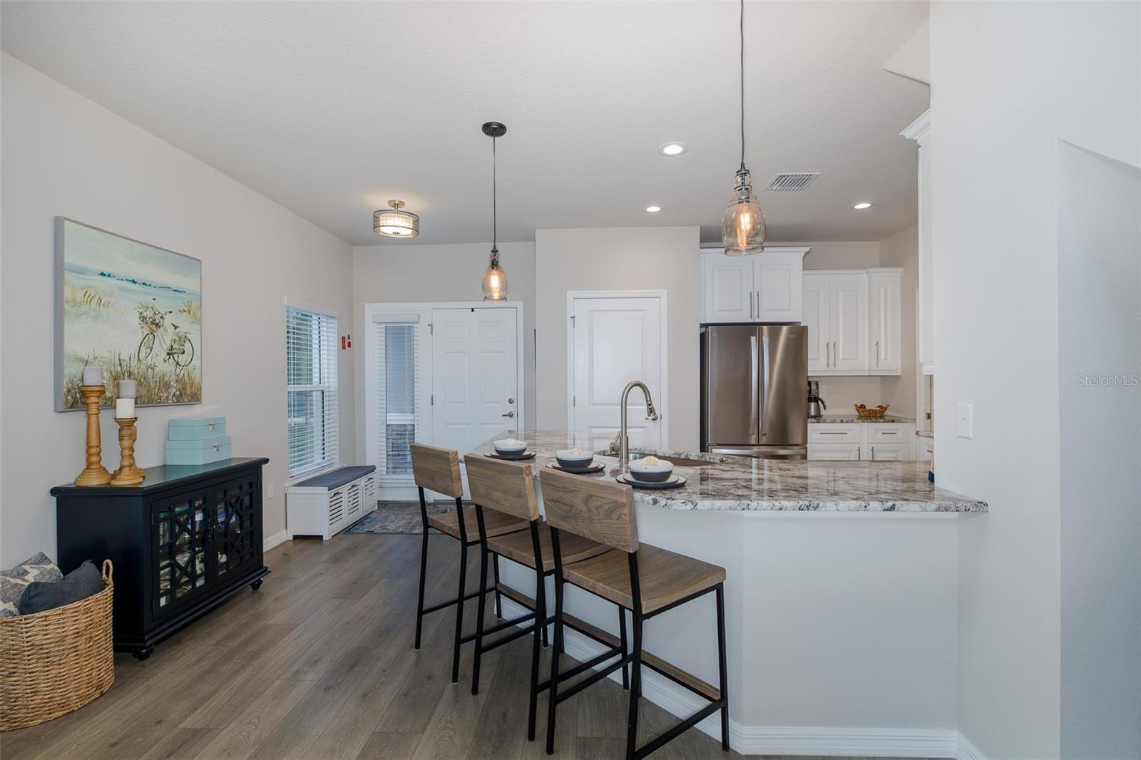 Kitchen and entry looking toward front door