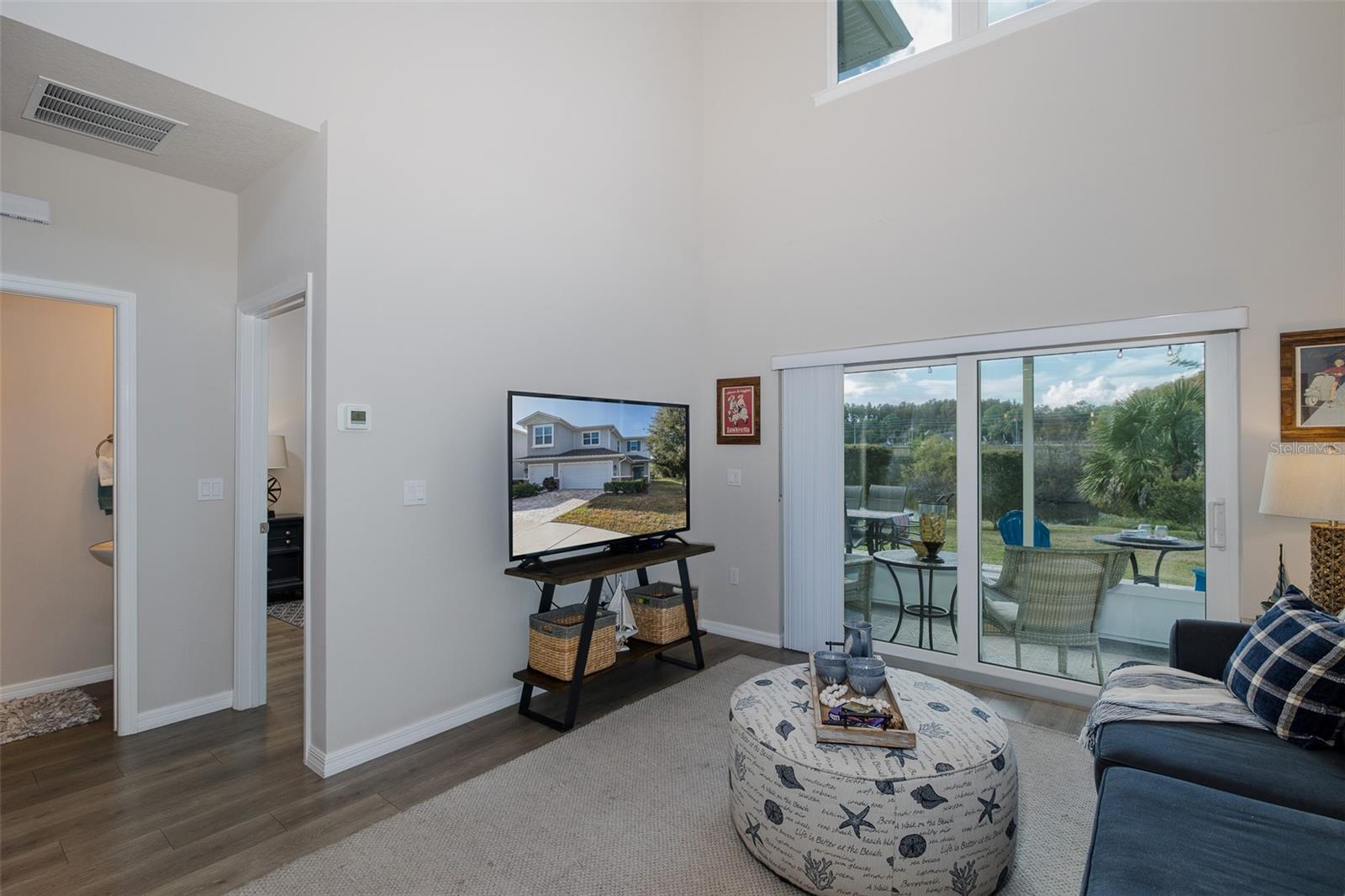 Living room, half bath and primary bedroom entrance