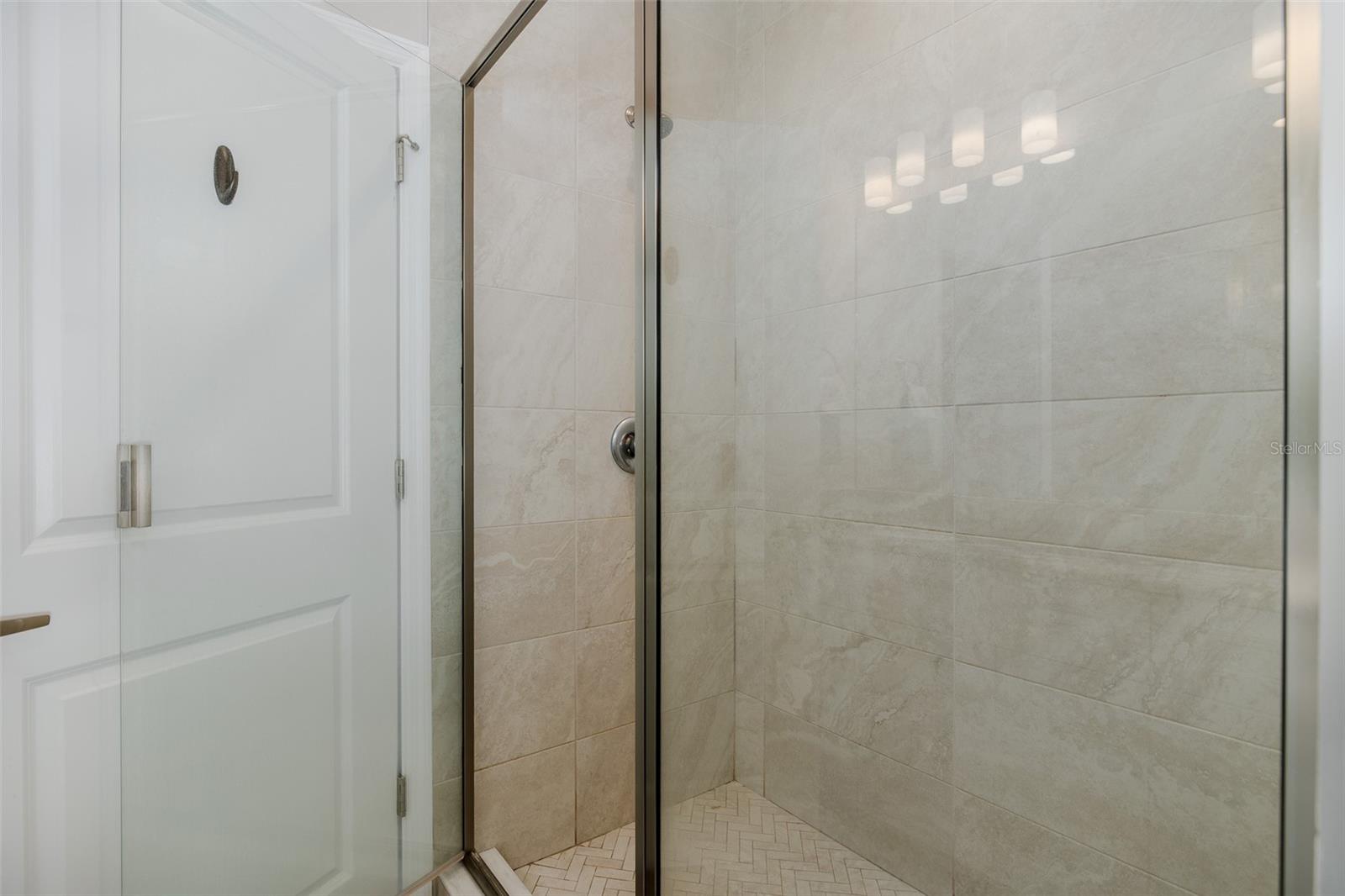 Large glass enclosed tile shower