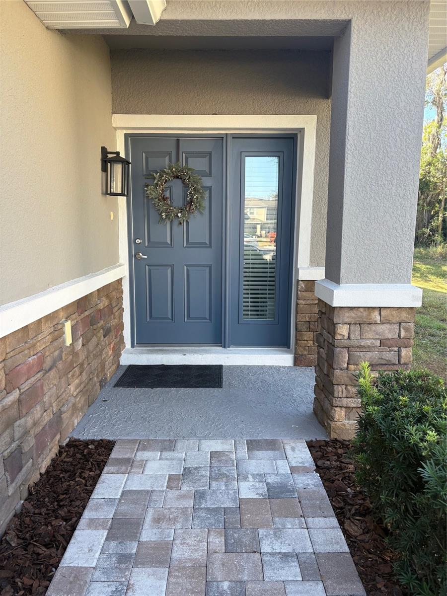 Paver walkway and stonework leading to front door