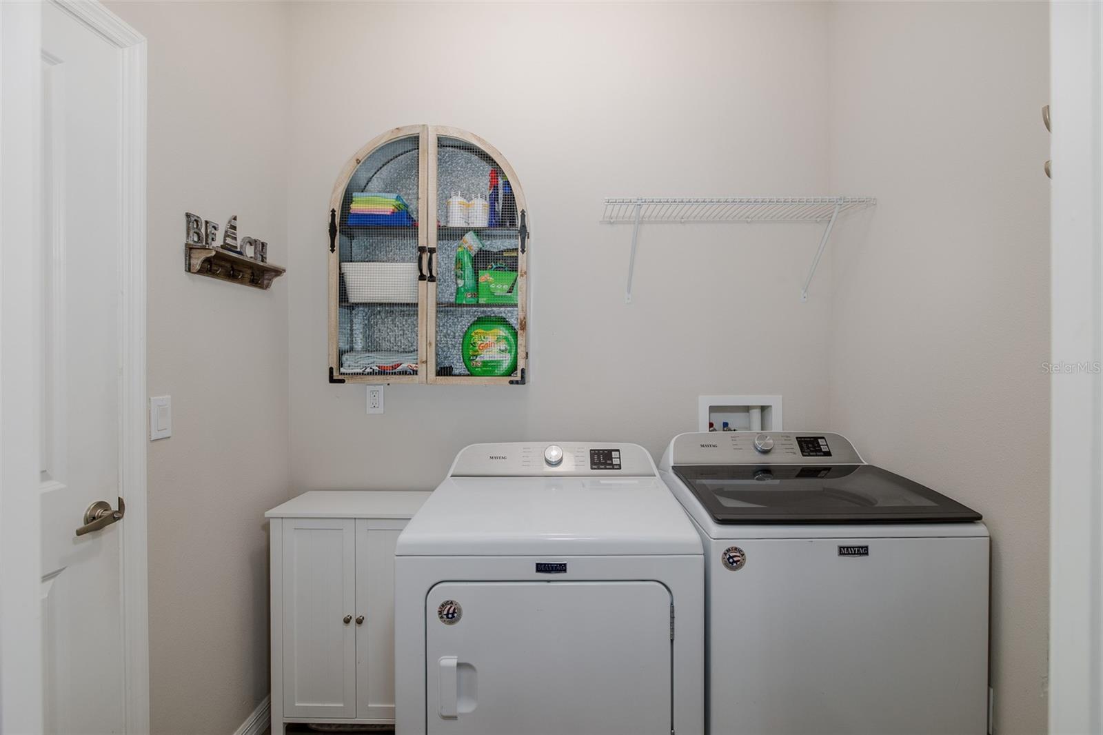 Laundry room off kitchen leading to garage